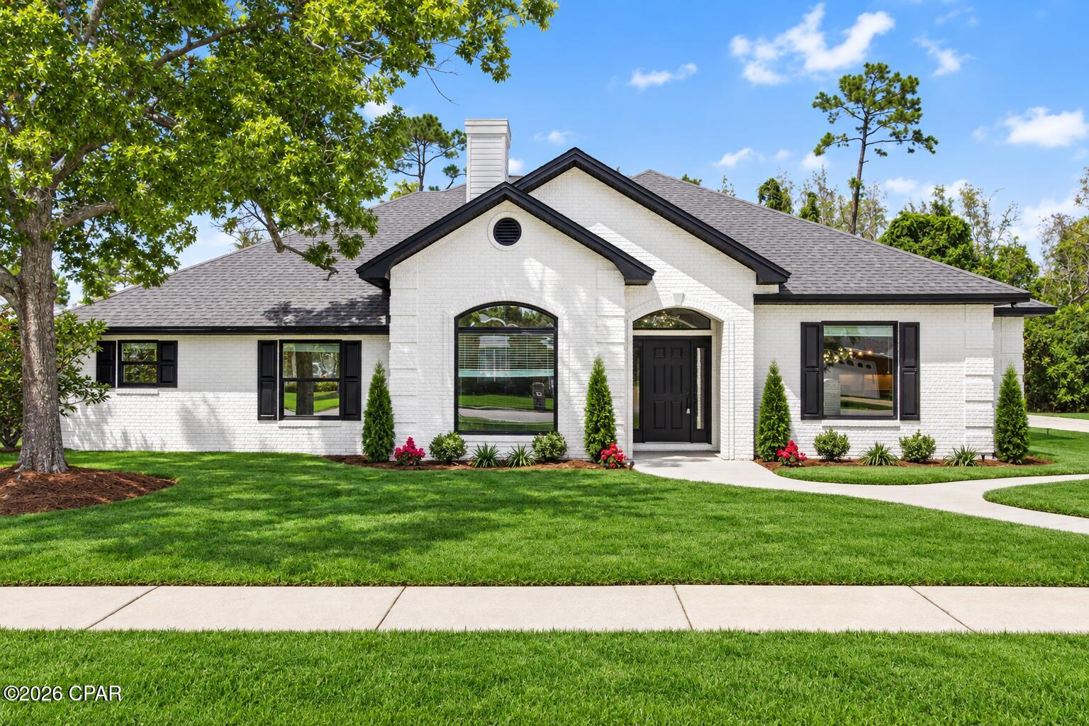Timeless elegance meets refined modern design in this stunning 2,840 sq ft, 4 bed, 2.5 bath home. From its striking white German schmear exterior and manicured garden to its thoughtfully curated interior, every detail has been designed to create a home that feels both sophisticated and inviting.
Inside, warm wood tones and crisp finishes create a welcoming atmosphere, while distinctive architectural details add character throughout. The living room makes an unforgettable impression with a dramatic floor-to-ceiling electric fireplace feature framed by custom built-in shelving, creating an elegant focal point for both everyday living and entertaining.
The kitchen is truly the heart of the home, offering an impressive combination of style and functionality. Ample soft-close cabinetry, a spacious center island with bar seating, and luxurious waterfall quartz countertops provide plenty of storage, workspace, and room to gather. White appliances with sophisticated gold detailing complement the warm wood accents and elegant finishes.
The primary suite offers a private retreat with a beautifully appointed ensuite bath featuring dual vanities, a spacious glass-enclosed walk-in shower, and a freestanding soaking tub. A generous walk-in closet provides abundant storage.
Two additional bedrooms offer flexibility for guests, a home office, study, hobby room, or whatever best suits your lifestyle. A closed-in patio area provides additional living space and creates a comfortable setting for relaxing or entertaining.
Combined with its sophisticated design, thoughtful upgrades, beautiful landscaping, and attention to detail, 305 Wood Trail is a truly distinctive home that seamlessly blends classic architectural charm with contemporary luxury.