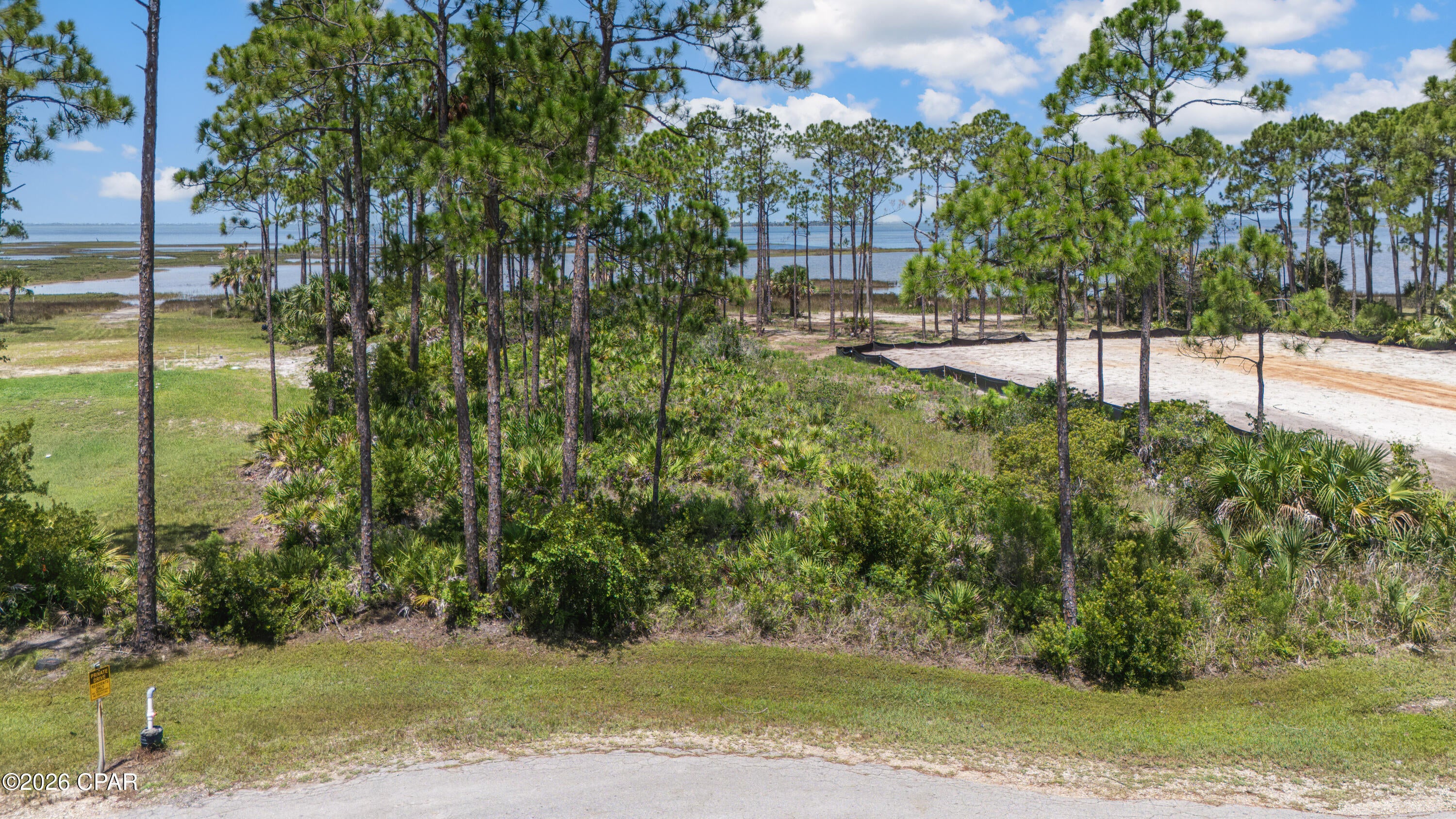 BAY FRONT-Heron Bay Lot #5 - 1.61 Acres with 115' feet of Bay Frontage. Escape to your own slice of the Florida Panhandle on this beautiful 1.61-acre wooded homesite, boasting 115 feet of pristine frontage on St. Joseph Bay. Whether you're dreaming of a peaceful vacation retreat or a full-time coastal residence, this lot offers the natural privacy and setting to make it happen. Picture evenings spent on your future deck, watching the sky turn brilliant shades of orange and pink over the water. Step down to your own private shoreline and launch a kayak or canoe directly into the bay -- ideal for exploring calm waters and observing local wildlife up close. The area is also renowned for excellent snorkeling and scalloping during season, making this a true outdoor enthusiast's dream come true. Close to Cape and Indian Pass beaches, several boat launches in the area. With mature trees providing natural shade and privacy, this lot offers a rare opportunity to build a waterfront home in a secluded scenic area. Don't miss your chance to own a piece of paradise.