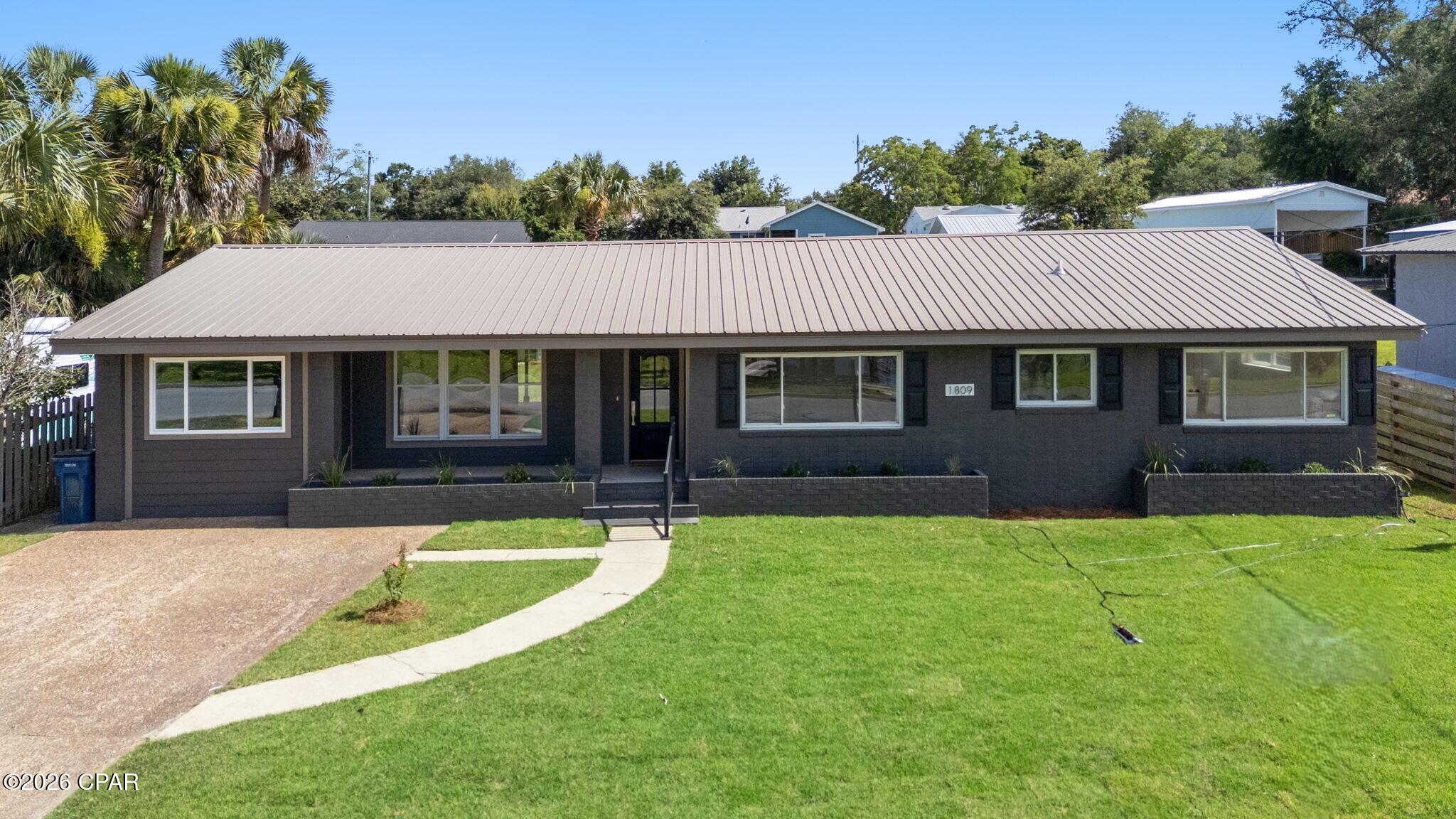 ***Seller is offering a $10,000 incentive for buyer to use however they would like!***
Welcome to 1809 DeWitt Street, where timeless Cove charm meets modern luxury. Perfectly positioned to capture stunning protected water views, this 4 bed 3 bath completely reimagined ranch-style home offers a rare opportunity to enjoy one of Panama City's most sought-after neighborhoods without compromise.

Every inch of this home has been thoughtfully renovated with an emphasis on quality craftsmanship, elegant finishes, and effortless everyday living. From the moment you arrive, you'll appreciate the attention to detail that transforms this property from simply updated to truly exceptional.

Inside, you'll find bright, inviting living spaces designed to maximize both comfort and style. The seamless blend of modern finishes and classic character creates a warm, welcoming atmosphere that feels instantly like home. Whether entertaining guests or enjoying a quiet evening overlooking the water, every space has been carefully curated to showcase the home's unique setting.

One of the property's most remarkable features is its protected water view--an increasingly rare amenity that provides a picturesque backdrop and a sense of tranquility that few homes can offer. Enjoy morning coffee as the sun rises over the water or unwind in the evening while taking in the peaceful scenery that makes this location so special.

Adding to the property's versatility is a detached climate-controlled storage building, offering endless possibilities as a workshop, hobby space, home office, fitness room, studio, or secure storage for valuable belongings. Having heated and cooled flex space separate from the main residence is a rare and highly desirable feature that enhances both functionality and value.

Located in the heart of The Cove, residents enjoy one of Panama City's most beloved neighborhoods, known for its mature trees, waterfront parks, golf-cart-friendly streets, and close proximity to downtown St. Andrews, marinas, dining, shopping, and entertainment. Opportunities to own a fully renovated home with enduring water views, flexible bonus space, and the unmatched lifestyle of The Cove are exceptionally rare.

This is more than a home--it's a lifestyle.