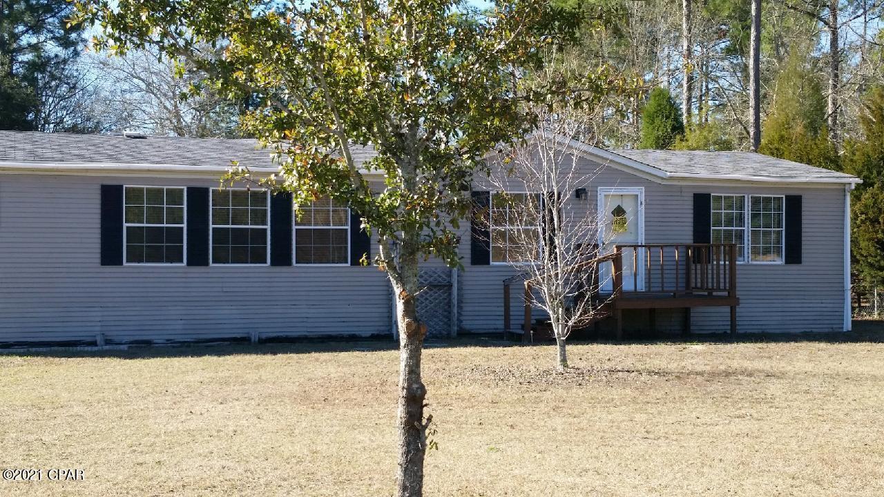 'CURRENTLY UNDER CONTRACT, SELLER ACCEPTING BACKUP OFFERS  pending inspection.  This 3 bedroom mobile sits on a 1/2 acre lot in an excellent location. Convenient to beach, own and Lynn Haven. It has an open floorplan, Vinyl laminate flooring, updated kitchen with all appliances. Sliding glass door leading to large back deck. Large yard building in Yard.  Property is being sold as is. Yard is in process of being cleaned up.
