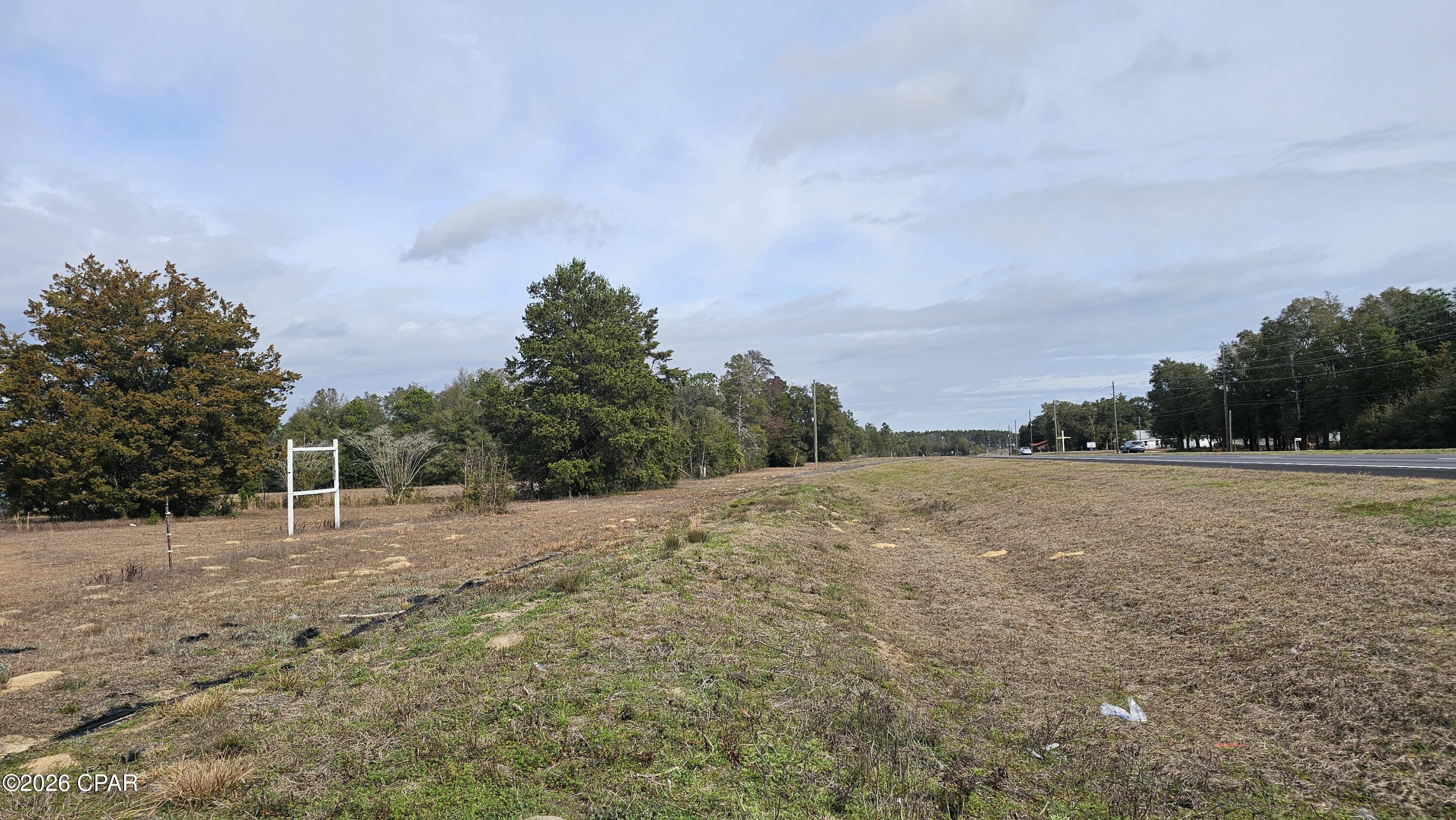 Great 1.38 acre lot to build your beautiful dream home with plenty of room left to run and play. PROPERTY HAS WORKING WELL AND SEPTIC. Super easy access to I-10, Chipley, NW FL Int'l Airport, Panama City, and Panama City Beach, home of our gorgeous emerald-green ocean waters and white sand beaches. Also, you're close to many recreational springs and all the very best NW FL has to offer. Note, that current MH is not suitable for living in and will need removed. **NOTE Property includes TWO LARGE 2-CAR GARAGES w/GARAGE DOORS (which are expected to be empty by closing or before) PLUS a 4-CAR GARAGE/WORKSHOP in back. (** For approximately $1000-$1500 property can be converted to commercial. Check out Washington County FLUM app on their website.**)