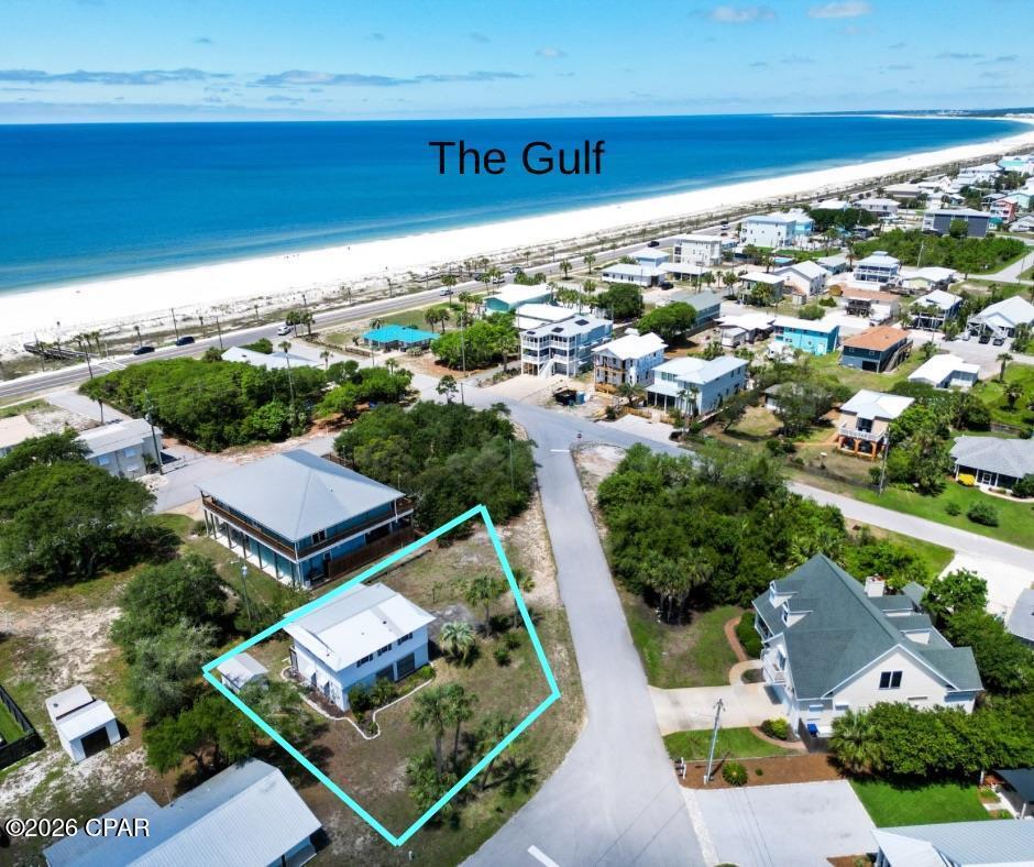 Discover coastal living at its finest in this inviting 3BR/2B home nestled on a large corner lot in the highly sought-after Bluff area of Mexico Beach. JUST ONE BLOCK from the sand, this raised beach house offers elevated living, plentiful natural light, and multiple outdoor spaces designed to capture the refreshing Gulf breeze. The top level is the heart of the home and designed for easy coastal living. An open living/dining/kitchen arrangement provides space for gatherings and everyday comfort, while large windows and a breezy layout invite natural light and sea air. Two comfortable bedrooms and a full bath on this level make it simple to sleep and relax on the main living floor. A standout feature is the large sunroom on the top level -- the perfect spot to sip morning coffee, read a book, or catch an afternoon Gulf breeze while enjoying views of the neighborhood and trees. The sunroom expands your living space and brings the outdoors in without sacrificing comfort. Downstairs, just off the carport, you'll find a private third bedroom with its own full bath and the laundry room -- ideal for guests, an in-law setup or a home office. This lower level also catches the breeze, offering a cool retreat even on warm days. A backyard storage shed stores beach gear, bikes, and seasonal items, while the outdoor shower is perfect for rinsing off sand before stepping Inside. Located in the Desirable X Flood Zone (lower insurance exposure). No HOA and no high rises, a relaxed coastal lifestyle. Walkable neighborhood with sidewalks, restaurants, and quaint shops nearby. Being only one block to miles of sandy beach means strolls at sunrise, shelling afternoons, and easy access to swimming, fishing, and beachcombing. Evening beach walks culminate in the area's famed spectacular sunsets -- a nightly show that's hard to beat. New HVAC installed May 2026. Roof replaced in 2019. ALSO INCLUDED: $9,200 Credit at Cathey's Ace Hardware in Mexico Beach, FL.