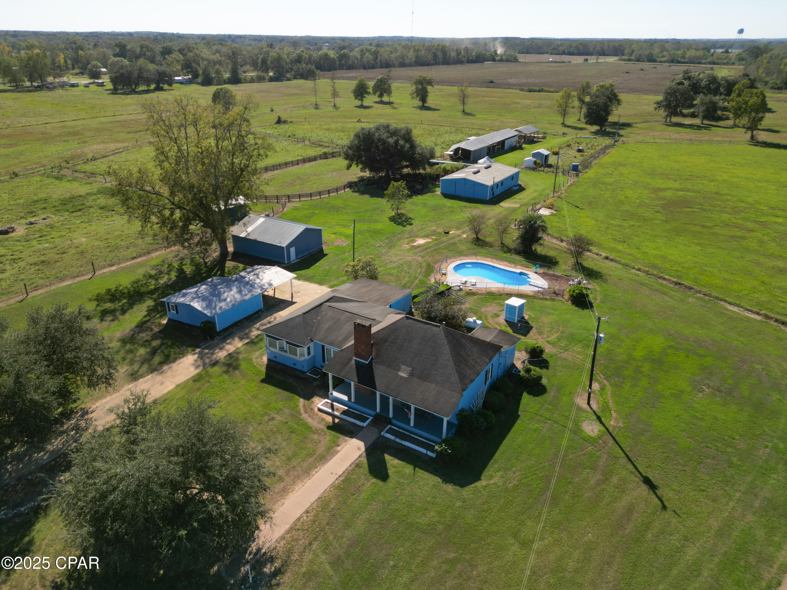 Bring your horses and enjoy country living at its finest! This beautiful 1907 farmhouse offers 2,815 heated and cooled square feet and sits on over 54 acres just outside of Graceville, FL. The home is full of historic farmhouse charm and being sold partially furnished with tall ceilings, spacious rooms, and plenty of character throughout. Features include a cozy living room, large den, and formal dining room--perfect for family gatherings.

The property is set up and ready for your animals with a 10-stall horse barn complete with power, water, skylights, and a storage room. There are also multiple pole barns and storage buildings for hay, tractors, or equipment. The land is fenced and is ideal for horses, cattle, goats, or chickens. Deer are plentiful, providing excellent hunting opportunities, and there's even a fully stocked catfish pond with a fish feeder for quiet evenings by the water.

Investor, equestrian, mini-farm, or homestead opportunity! This unique property offers multiple purchase options with flexibility to fit your vision. Featuring barns, open acreage, and a pond, the possibilities are endless for farming, recreation, or building your dream estate.

Purchase options include:
• Entire property with barns and 32± acres -- $425,000
• South 10± acres -- $140,000
• North 12± acres with pond -- $165,000

Or purchase everything together at a discounted package price of $599,995! Rare opportunity to secure acreage with existing improvements and water features in one purchase or divide to suit your needs. Call today for additional details and showing appointments.