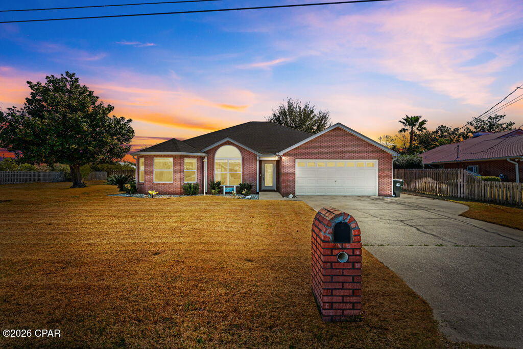 'CURRENTLY UNDER CONTRACT, SELLER WILLING TO ACCEPT BACK-UP OFFERS.' Beautifully updated and move-in ready, this 3-bedroom, 2-bath split floor plan home offers space, privacy, and thoughtful upgrades throughout. Situated on approximately 0.34 acres, the property is aligned next to a neighborhood easement providing additional open space and privacy. The home underwent a major renovation in 2020 with numerous upgrades, including RevWood flooring, updated kitchen cabinetry and bathroom vanities, windows, HVAC system, roof, spray foam insulation, gutters, doors, trim, baseboards, lighting fixtures, switches, outlets, and interior paint. A Generac whole-house generator adds peace of mind during storms or power outages. 

Inside, the living and dining areas feature cathedral ceilings with beautiful cedar beams, while crown molding throughout adds an elegant finishing touch. The living room fireplace has been updated with electric fire logs for easy enjoyment. The spacious primary suite features a distinctive cedar box beam ceiling and an ensuite bath with a large walk-in shower with dual shower heads, bench seating, and a marble vanity top.

The fully fenced backyard offers plenty of room for outdoor living and includes raised garden beds perfect for flowers, herbs, or homegrown vegetables. The adjacent easement creates a unique sense of openness rarely found in neighborhood settings.
Conveniently located near schools, shopping, and just a short distance from North Bay, this home combines modern updates with comfortable living in one of Lynn Haven's most desirable areas.
All measurements approximate; buyer to verify if important.