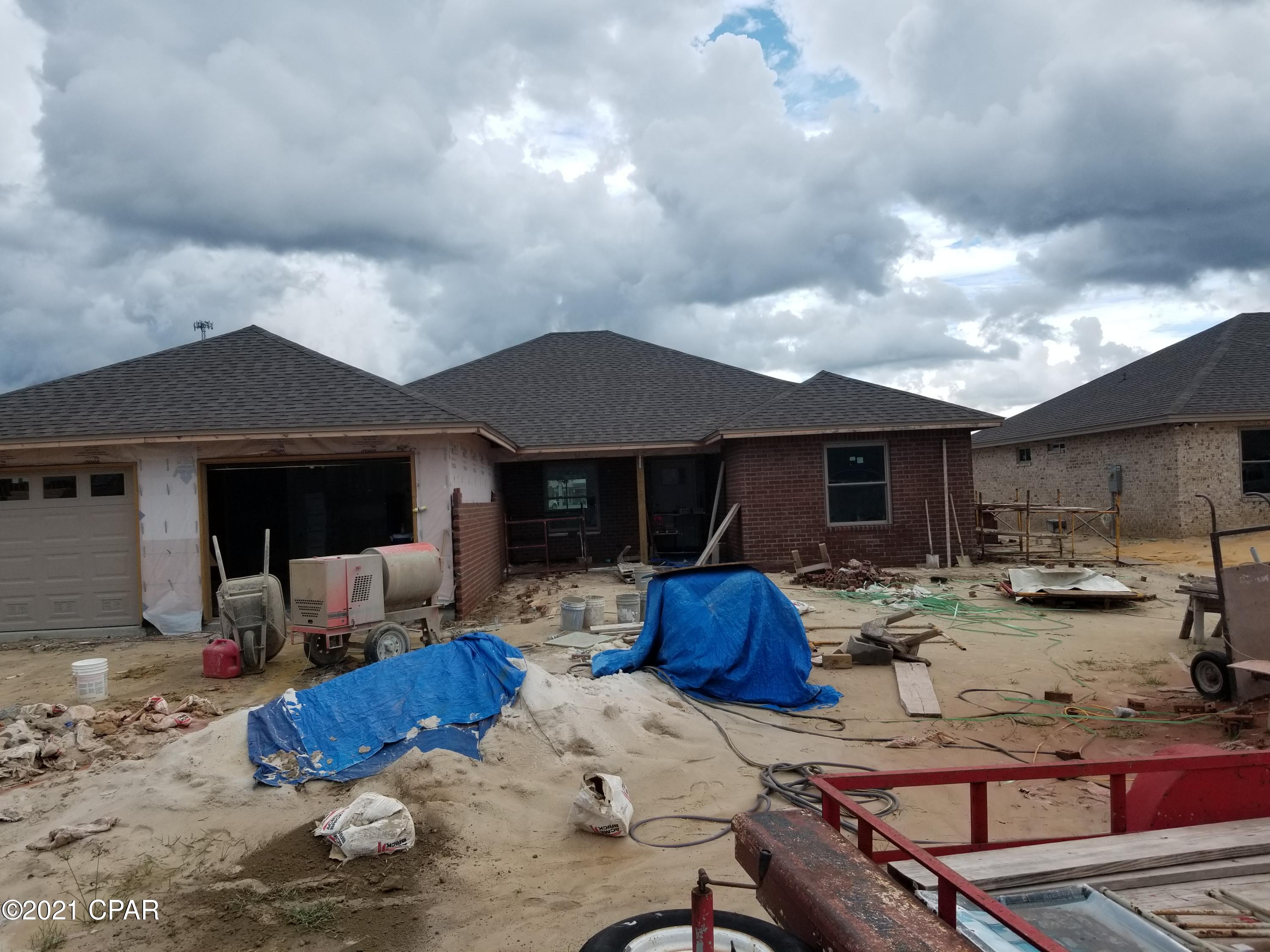 Under construction, luxury 4 bedroom 2 bath all brick home that offers large open floor plan, Master bath with his & hers double shower with Rain maker (3 shower heads) and shower seat, double vanity, large master bedroom with built-in rope lighting and large walk-in closets. The kitchen is a dream with all real hard white wood cabinets, granite countertops, stainless steel appliances, cabinets in the laundry room. Living room with high tray ceilings with rope lighting, electric fire place, crown molding and wired for entertainment. Home comes with large Florida room, front porch, and open back porch, security system, thermoseal spry foam system and generator ready electrical outlet with cord. outside shower and sprinkler system. Hurricane built See pictures. Lock in price before it go up again. We use Simpson Tie down and corner tie down straps and brackets, walls bolted to foundation as well as 2+6s. DP 50 windows, hip roofing just a few we do for a strong hurricane strength house. See pictures with out dry wall. About 90 days out from completion.