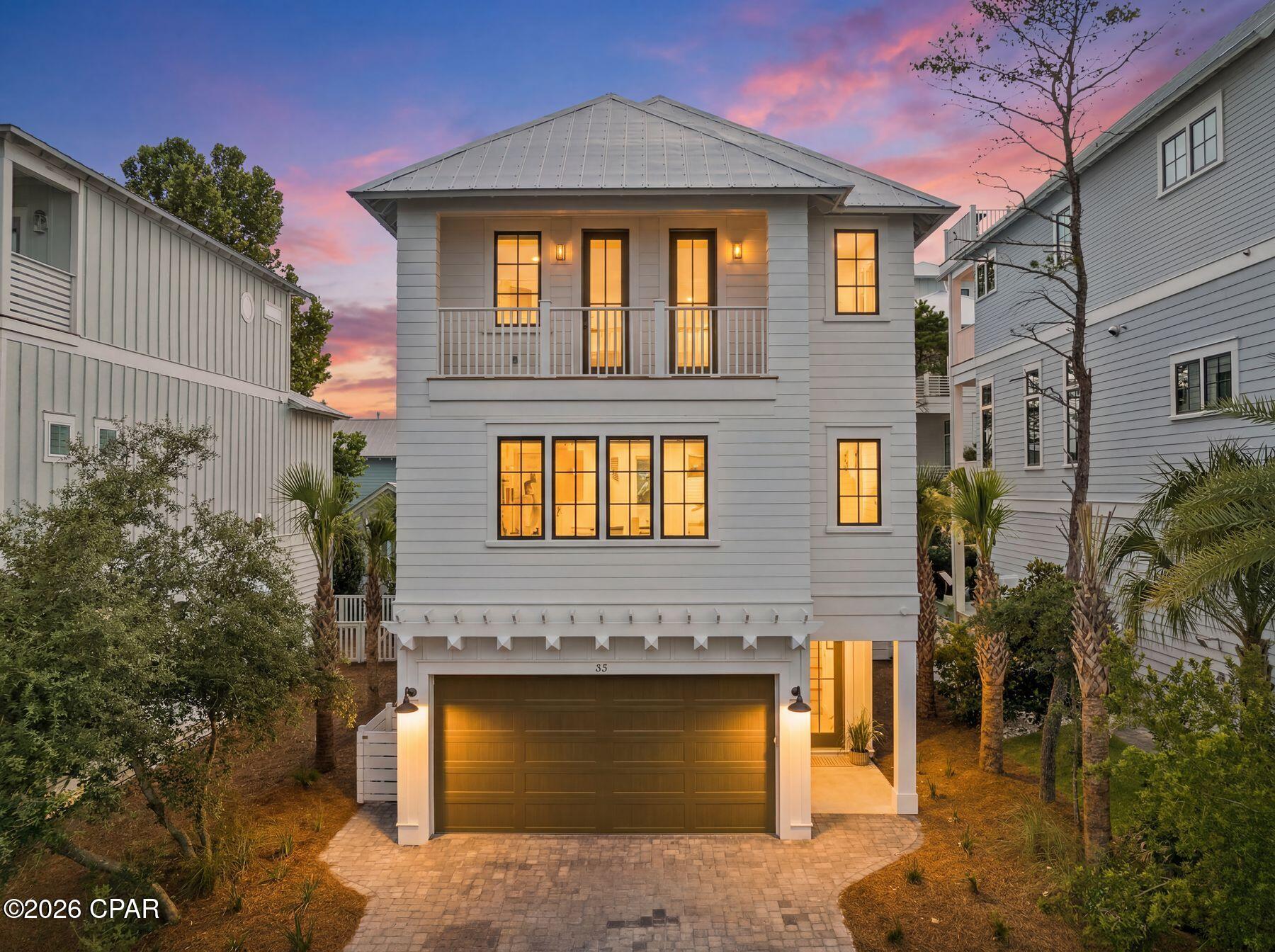 Completed New Construction in Grande Pointe at Inlet Beach. Nestled within the thoughtfully developed community of Grande Pointe, this exquisite three-story residence by 30A Builders seamlessly blends coastal design with contemporary elegance. Offering over 2,900 square feet of heated living space, the home is thoughtfully designed across three spacious levels, delivering a harmonious balance of style and function. Inside, rich hardwood flooring flows throughout, complementing the 10-foot ceilings and tongue-and-groove wood accents that add warmth and character to the home. With the convenience of an elevator designed to service all floors. The heart of the home is a beautifully appointed kitchen featuring custom cabinetry, a 48'' range, dishwasher, and large pantry.
The open-concept layout continues into the expansive great room and dining area, ideal for gathering and entertaining. The living room features a sleek horizontal fireplace and French doors that open to the first-floor balcony, creating a seamless connection between indoor comfort and outdoor relaxation. The third-floor primary suite serves as a private retreat, complete with a large walk-in closet, dual vanities, and balcony access. Two additional bedrooms and tastefully designed bathrooms ensure comfort and privacy for family and guests alike.

Step outside to discover your private backyard oasis, featuring lush landscaping and a generously sized pool perfect for cooling off or lounging under the sun. Exterior highlights include board and batten siding with mitered corners, standing seam metal roofing, and charming wood arbors. Enjoy multiple outdoor living areas, including covered porches and balconies on every level. From its curated interior finishes to its idyllic setting in Grande Pointe, this home is a rare blend of craftsmanship, comfort, and coastal sophistication. Estimated completion date May 2026
