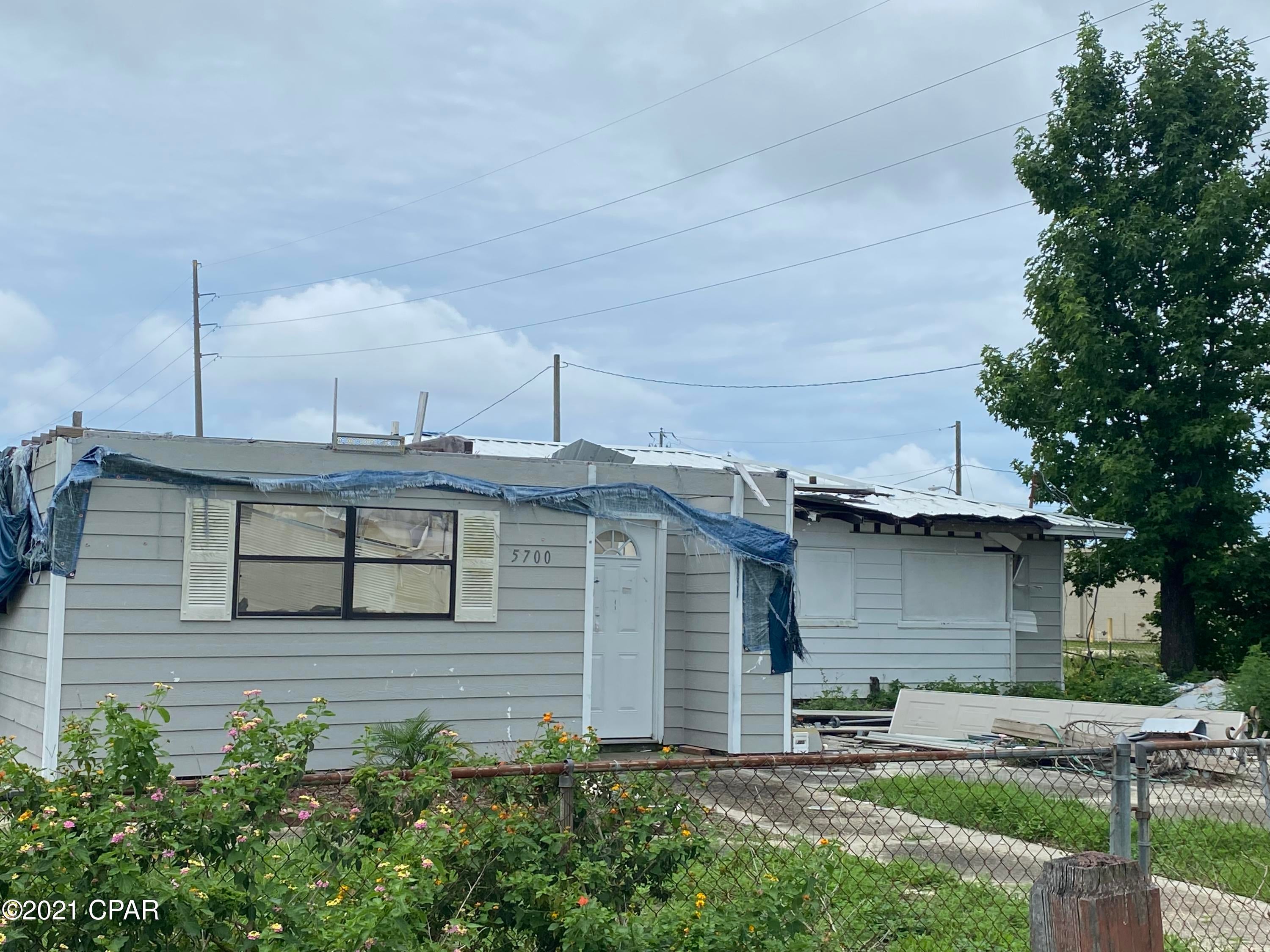 Storm Damaged Home, value is in the Lot. Located off Tyndall Parkway. Theres county water and sewer on the lot. Seller will not remove the house.  Please verify all information.