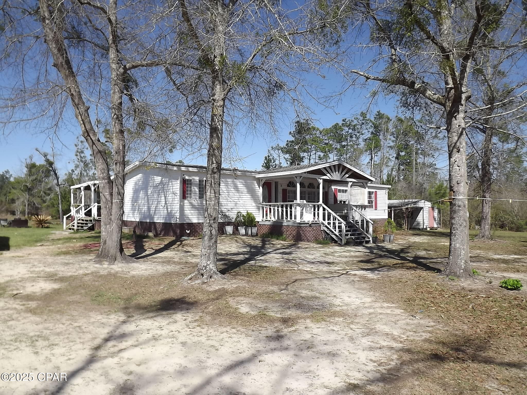 Nice Triple-wide on 10 Acres with Storage shed and 3 vehicle Garage/Barn parking nice little fishing pond and enough room for additional structures and Horses.  Great place for a Mini farm or your own Garden.  Close to Panama City and Marianna  The quiet Country Life  Come take a look  Lets make this your Country Home or Retirement Home.  Watch the wildlife out the kitchen window and enjoy your coffee.  Make your appointment today.