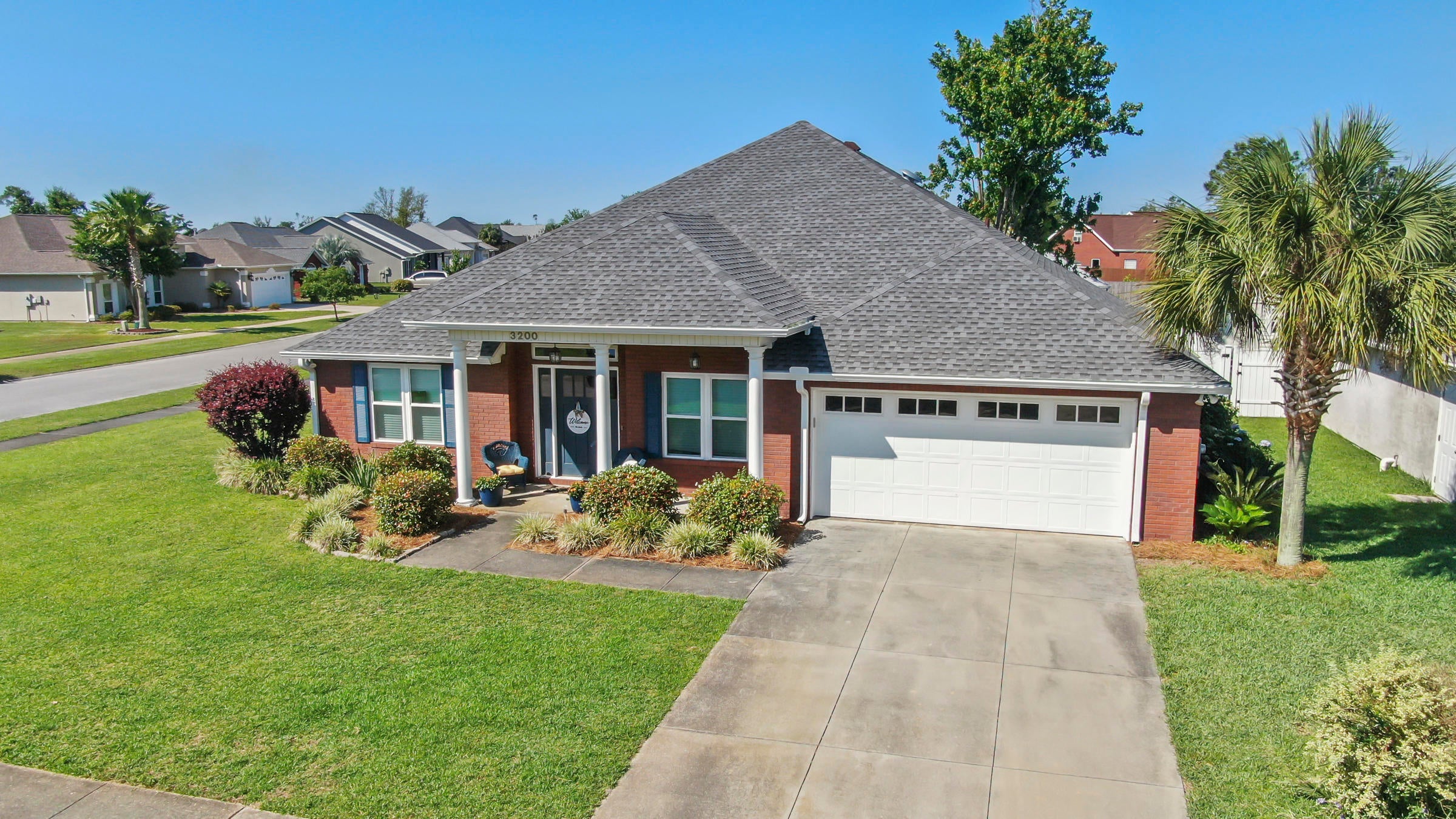 BEAUTIFUL BRICK HOME IN THE HAMMOCKS ON A CORNER LOT! This spacious home features 4 bedrooms, 2 full baths, a tastefully designed floor plan with split bedrooms (great for entertaining), 2 dining areas, 2 living rooms, an interior laundry room and a 2 car garage. The kitchen boasts granite counters, stainless steel appliances, a pantry and a breakfast bar. The master bedroom can accommodate king size furniture and has an adjoining master bath with double sinks, walk-in shower and two large closets. The other three bedrooms are good size and share the hall bath. The exterior features a covered front porch, an open back patio, and a white vinyl privacy fenced backyard. RECENT UPGRADES: roof, windows, garage door, Insulation, well pump (for irrigation), LVP flooring, gutters, etc. This home is conveniently located in a sidewalk community that has underground utilities and a community pool. Call today for your own private preview.