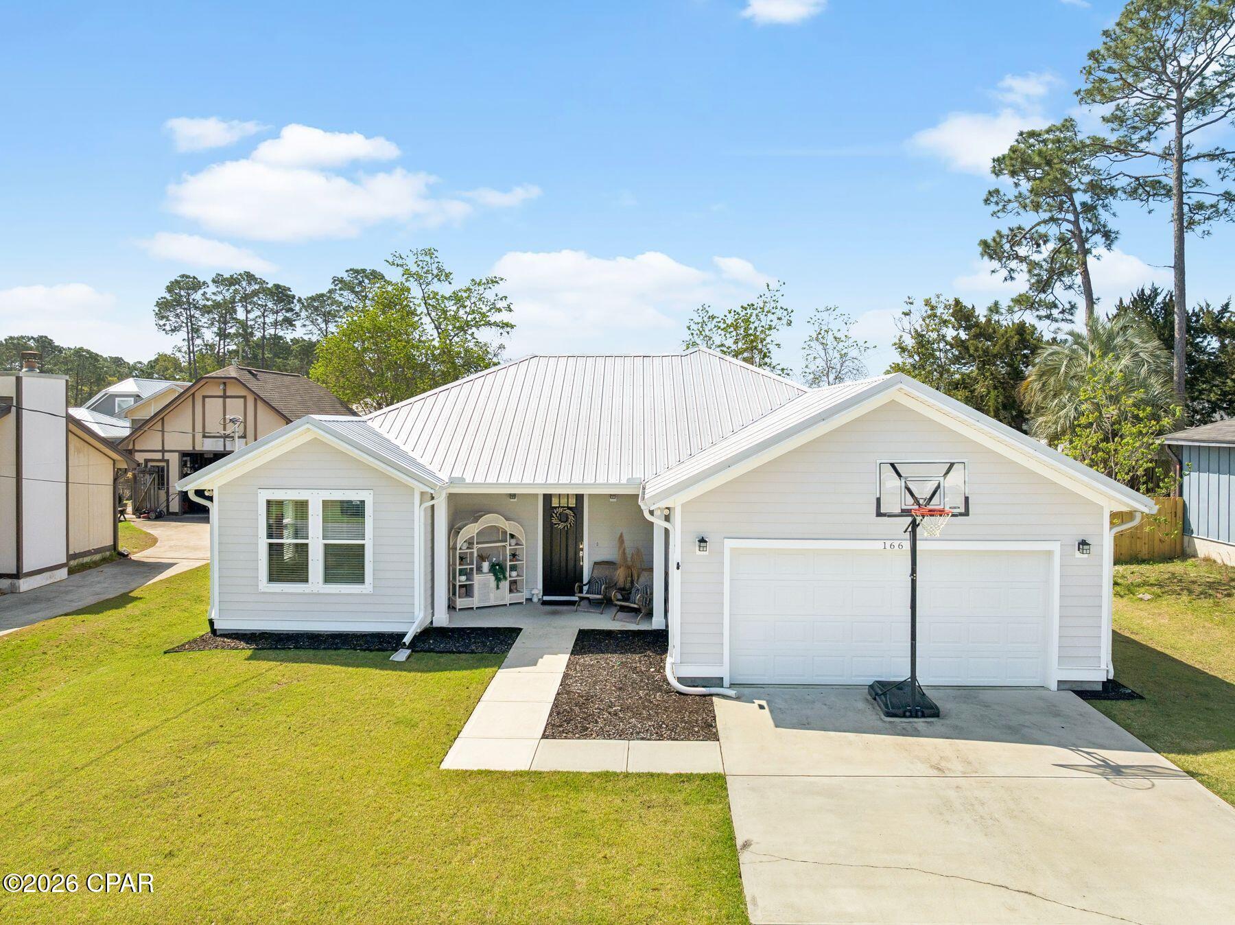This beautiful, newer home, with a fully fenced in backyard, combines modern style, comfort, and convenience, in one of the area's most desirable locations.

Inside, you'll find an open and inviting floor plan featuring wood-look tile flooring, engineered hardwood accents, designer lighting, and high-quality finishes throughout. The spacious kitchen is perfect for cooking and entertaining, complete with modern cabinetry, ample counter space, and a layout that flows seamlessly into the living and dining areas.

The private primary suite provides a relaxing retreat, while two additional bedrooms offer plenty of space for family, guests, or a home office. A durable metal roof adds lasting value and curb appeal.

Conveniently located just minutes from Pier Park, Frank Brown Park, the white sand beaches of the Gulf, scenic 30A, shopping, dining, entertainment, and Northwest Florida Beaches International Airport, this home puts everything you need within easy reach.

Don't miss your opportunity to make this exceptional home your next address--schedule your showing today!