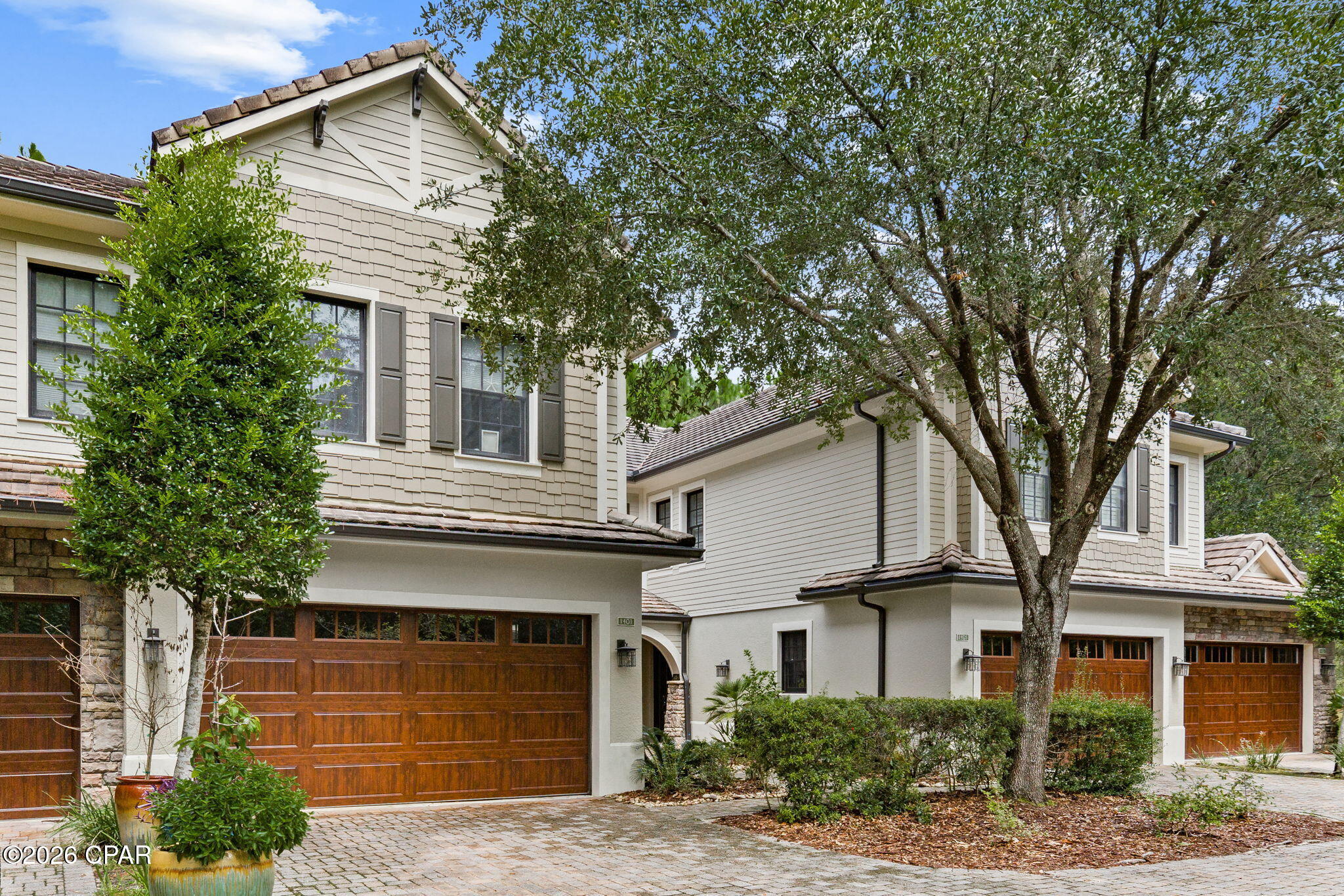 Welcome to 1401 Salamander Trail, a beautifully furnished residence tucked within the gated community of Wild Heron and offering peaceful views of the Shark's Tooth Golf Course. Offered fully furnished at $650,000, this home provides an easy, turnkey opportunity to enjoy one of Panama City Beach's most sought-after communities. The inviting interior features hardwood flooring throughout the main living areas, a spacious open-concept design, and abundant natural light. The kitchen is equipped with granite countertops, stainless steel appliances, warm wood cabinetry, a center island, and a breakfast bar overlooking the generous living area, perfect for entertaining or relaxing after a day on the course. Large sliding doors open the living space to an expansive screened porch, creating a seamless connection to the outdoors and a tranquil setting surrounded by mature pines with views toward the golf course. The primary suite offers a spacious retreat with an ensuite bath featuring dual vanities, a jetted soaking tub, separate shower, and generous cabinetry. With its charming architecture, attached garage, beautiful natural surroundings, and thoughtfully furnished interior, this property offers the perfect combination of comfort and low-maintenance living. Wild Heron residents enjoy access to an impressive collection of community amenities including Lake Powell, a lakeside pool, fitness center, walking and biking trails, community dock, boathouse, and more. The community is
also home to the private Shark's Tooth Golf Club, with membership available separately.