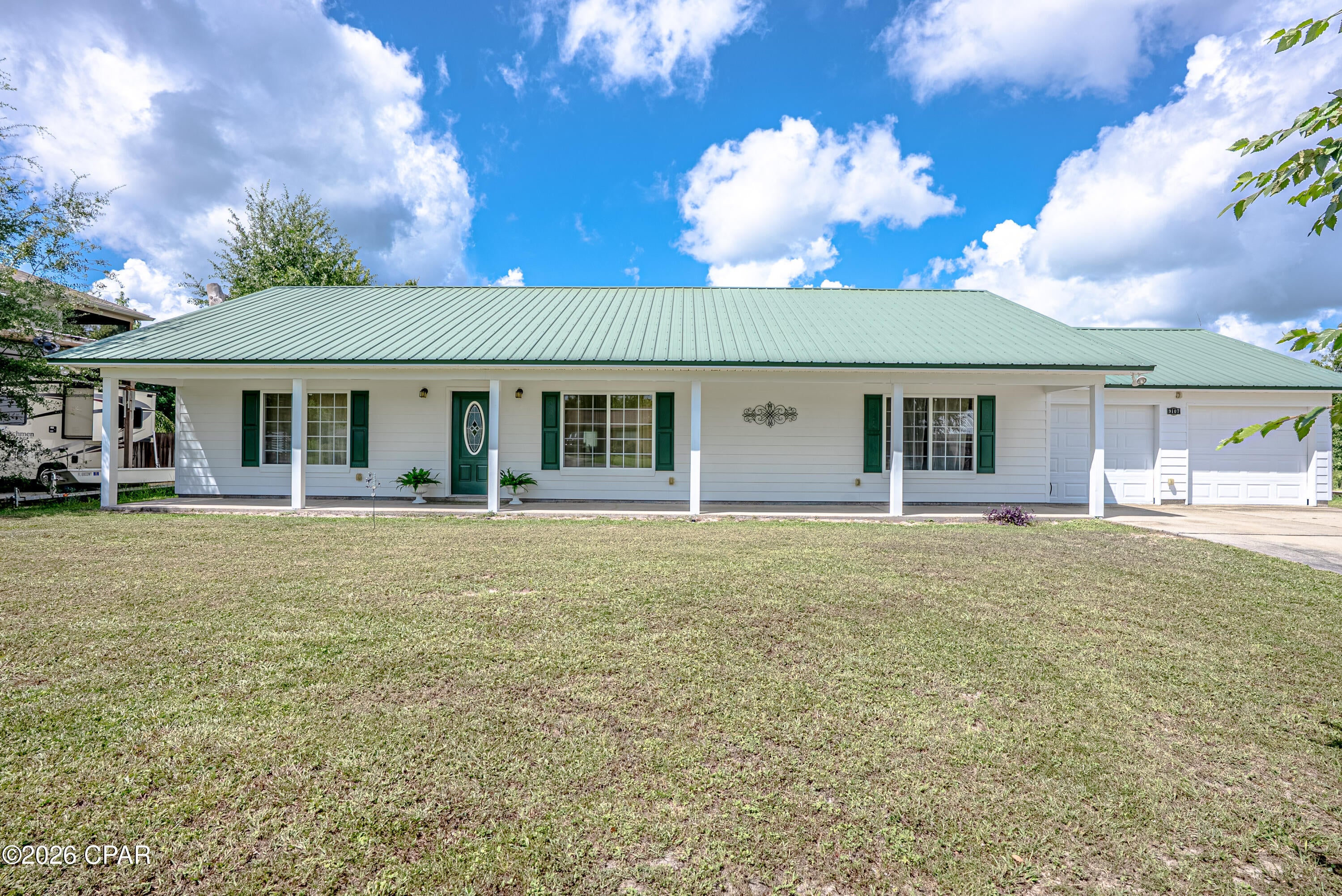 Welcome to this spacious and inviting custom-built home on almost half an acre offering generously sized bedrooms, 2 bedrooms that could easily be a 3-bedroom by adding a closet to the extra room that is now an office/sitting room.  Comfortable living space with a large open great room and open dining room with plenty of room to enjoy the outdoors. The open floor plan welcomes you in, and with a split bedroom plan you have privacy.  

The kitchen features Corian countertops, solid oak cabinets with plenty of cabinet space, Jenn-Air cooking island, open dining with French doors leading out to the spacious Florida room with windows and AC. 

There is  a large laundry area leading to the garage. The Laundry area has 2 closets for space, and room for a freezer. The double garage offers a workshop with AC and electricity, making it ideal for a workshop, hobby area, or additional workspace in the 2-car garage. The garage is equipped with a roll-up door for easy access to the backyard.       A separate storage shed and pump shed in the backyard provide extra space for storage and a work area.  The well is under cover in the pump house and is a deep well and the septic tank in in the front, leaving space in the backyard for storage or a pool.

Custom construction of the home with extra features as:
40 year warranty on Metal Roof
Double hurricane clips on roof
Double rods in the walls with 4' nailing pattern
Water softener owned 
Deep Well
Newer AC and Roof
Sprinklers front and back yard.

Step outside and discover a large backyard with a wooded area and a small stream. The stream winds through the wooded portion of the property and opens into a narrower section that may offer an opportunity for kayaking, fishing, or just creating a unique outdoor setting for nature lovers.

For boating enthusiasts, Cherokee Landing Boat Ramp is conveniently located approximately three minutes away, providing easy access to the water.

This property offers a combination of spacious living, excellent storage, workshop potential, and a peaceful natural setting--all in a convenient Youngstown location.

All measurements are approximate and should be verified by the buyer.