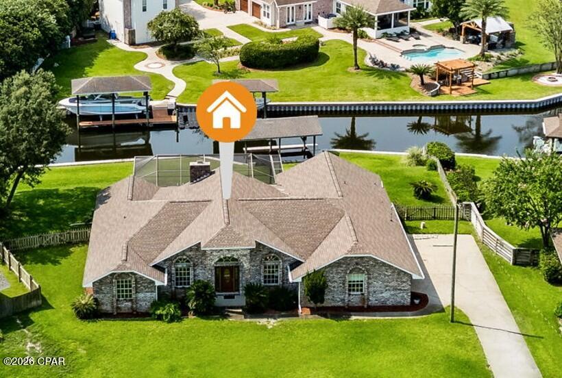 Beautiful canal-front home offering over 2,500 heated square feet with an open, split-bedroom floor plan designed for comfortable everyday living and entertaining. The spacious family room features a vaulted ceiling and wood-burning fireplace, creating a warm and inviting gathering space. The fully equipped kitchen includes a pantry, abundant cabinetry, and opens seamlessly to the main living areas.

The private primary suite offers a generous bedroom and an ensuite bath with double vanities, a garden tub, separate shower, and walk-in closet. Two additional bedrooms are located on the opposite side of the home for added privacy.

Step outside to enjoy Florida living at its best with a screen-enclosed in-ground pool, covered porch, and a large backyard overlooking the canal. Boaters will appreciate the vinyl seawall, covered boathouse, and direct water access. As part of the county's canal dredging project, the canal adjacent to the property was reported to provide an approximate water depth of five feet at Mean High Water (MHW), offering excellent access for many recreational boats. Approximate canal depth is based on the county's dredging information; buyers should verify suitability for their specific vessel and operating conditions. The oversized lot provides plenty of room for outdoor activities and entertaining.

Additional features include a 600-square-foot attached garage, inside laundry, mature landscaping, and a desirable location in King's Point. According to the Bay County Property Appraiser, the home offers 2,567 heated square feet, was built in 1988, sits on approximately 0.48 acres, and is located in Flood Zones X and AE, with the residence itself believed to be in Flood Zone X. Buyer should verify flood zone designation and insurance requirements.

A rare opportunity to own a spacious waterfront home with a pool, private boating amenities, and the lifestyle that makes Florida living so enjoyable.