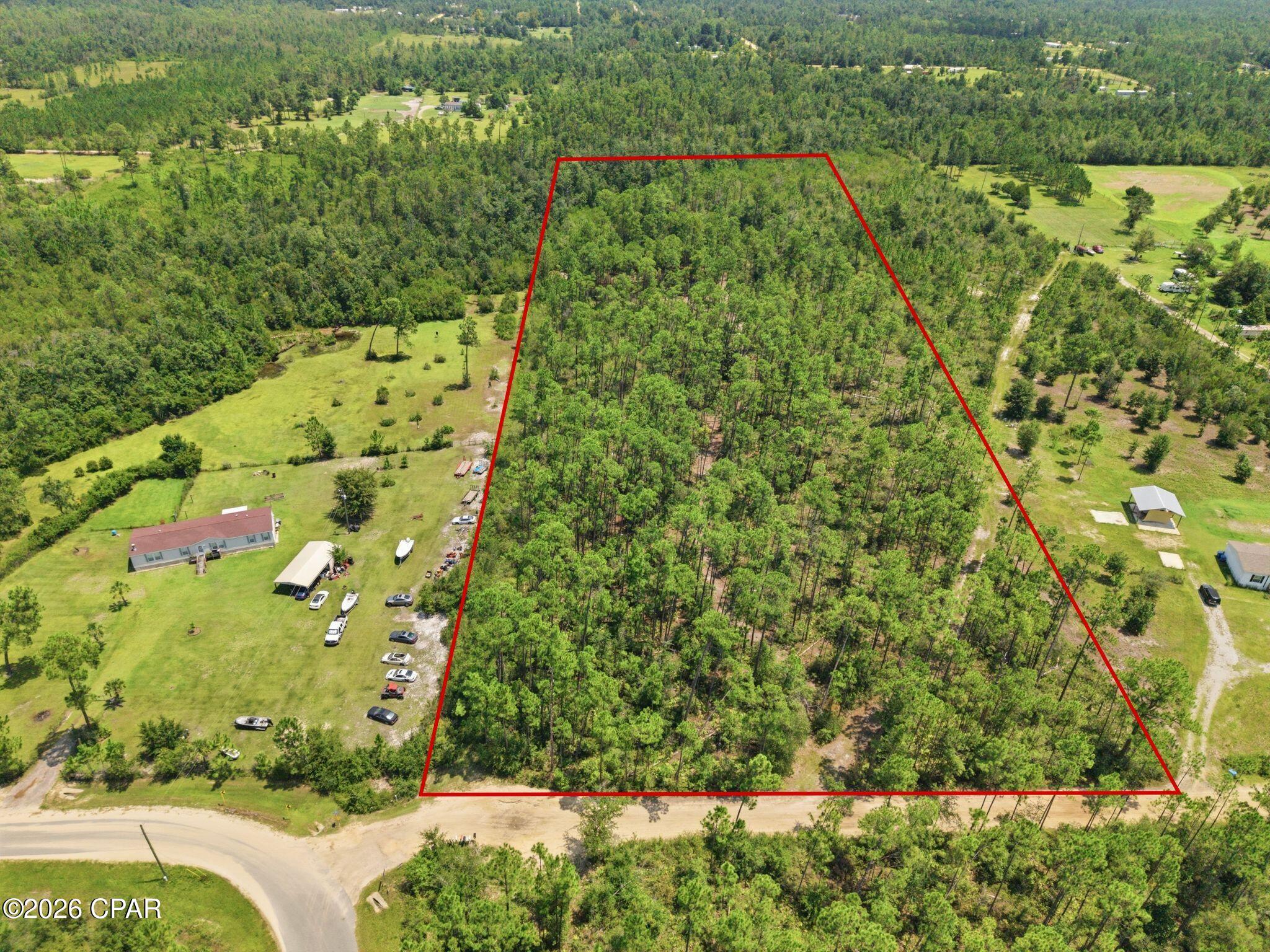 Discover the possibilities of 10 acres in Fountain, offering plenty of room to create the property you have been looking for. Whether your vision includes building a home, creating a private country retreat, or simply owning a larger piece of Northwest Florida land, this property provides the space and flexibility to make it your own. Conveniently located close to the main road, the property has an existing easement between the neighboring parcels with power available nearby, adding convenience for future plans. The land is high and dry with access from Alex Drive and is not landlocked. A survey is also available to help with planning and development. Enjoy the peace and privacy of a rural setting while remaining approximately an hour from the white sandy beaches, shopping, dining, and attractions of Panama City Beach. With 10 acres to work with, there is plenty of opportunity to bring your vision for the property to life.