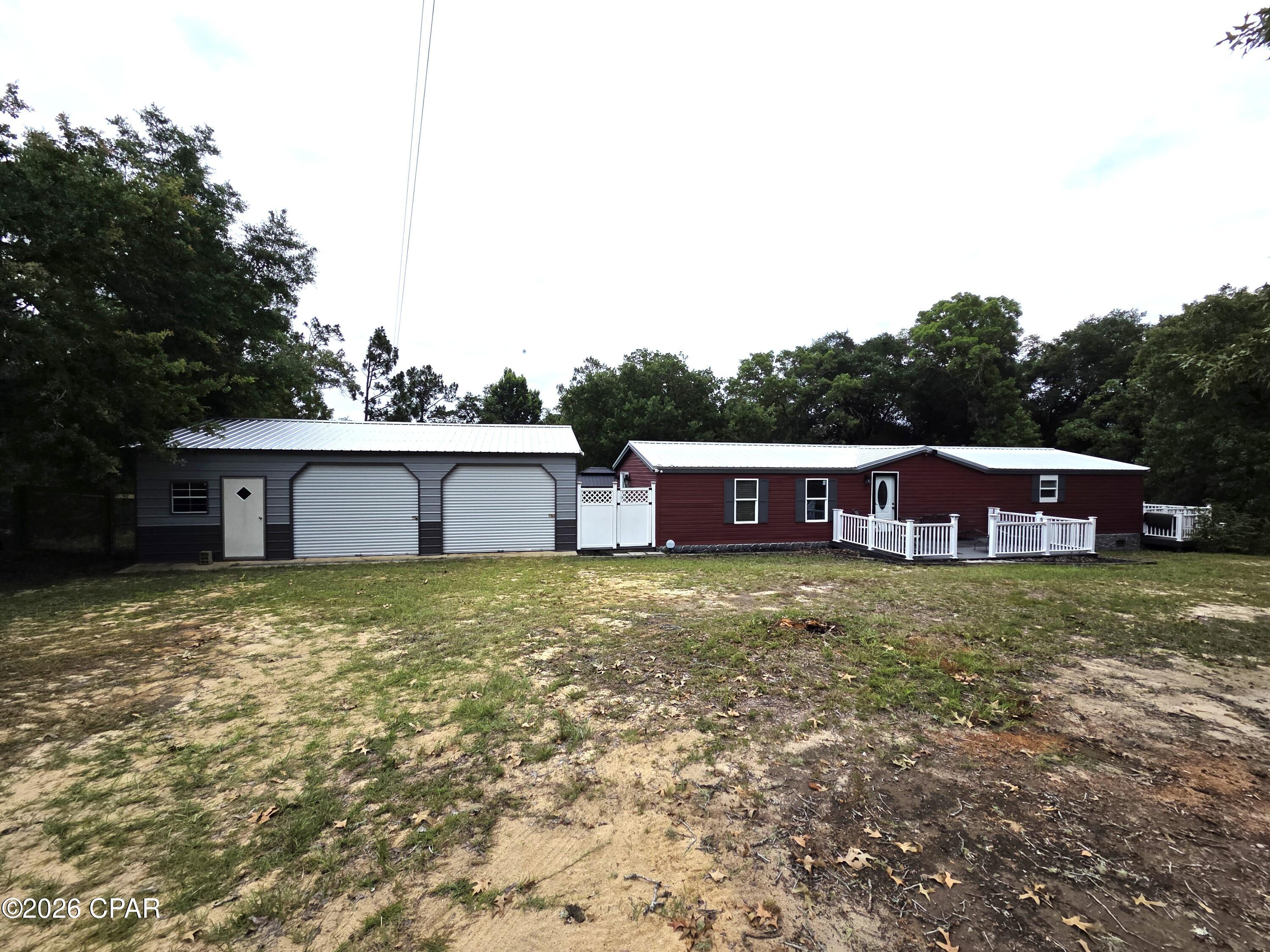 Discover this spacious retreat on a beautiful 4+ acre lot in Bristol, Florida. Just minutes from the Apalachicola River and Apalachicola National Forest, this property offers the perfect blend of privacy, convenience, and outdoor lifestyle.
The home features a durable metal roof, oversized living spaces with impressive arched wood ceilings in the living room. A separate dining room showcases shiplap walls and an accent wall, while the modern kitchen is equipped with stainless steel appliances, a double oven, new high-end refrigerator, and a pantry with double barn doors. Vinyl plank flooring flows throughout. The large master suite includes an updated ensuite bath with a modern shower. Additional highlights include a large private office with its own patio access, newer barn-style doors on guest bedrooms and baths, ceiling fans, and three sets of sliding glass doors that open to expansive outdoor living areas.
Step outside to Trex decking on the large front porch with white vinyl posts, plus a generous rear deck overlooking the enormous backyard. A Trex-covered back patio with a metal canopy off the office create ideal spaces for grilling and relaxing. Outdoor amenities include a newer metal barn with three roll-up doors and two walk-through doors with concrete floors, plus a 32 ft x 20 ft vinyl-sided barn with drive-thru boat storage. A completely fenced oversized back yard where your pets can roam free.  This move-in-ready home on acreage combines comfortable living with abundant storage and easy access to nature. Don't miss this rare opportunity!