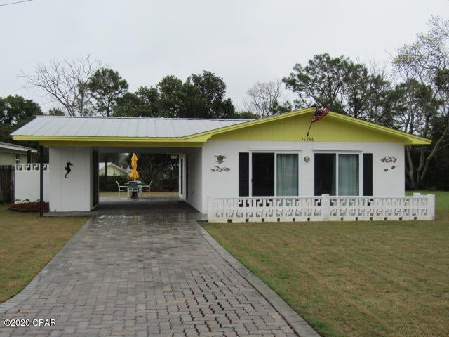 Beach cottage - 2 bedroom, 1 bath home featuring open living/dining area, breakfast bar with stools, terrazzo floors and paneled walls. Large brick paver patio area for entertaining. Storage shed.  Landlord provides water for sprinkler system and lawn weed control. Home is located near Hwy 79 with close proximity to beach. **$250 pet deposit/$50 pet fee/$25 pet rent (monthly)