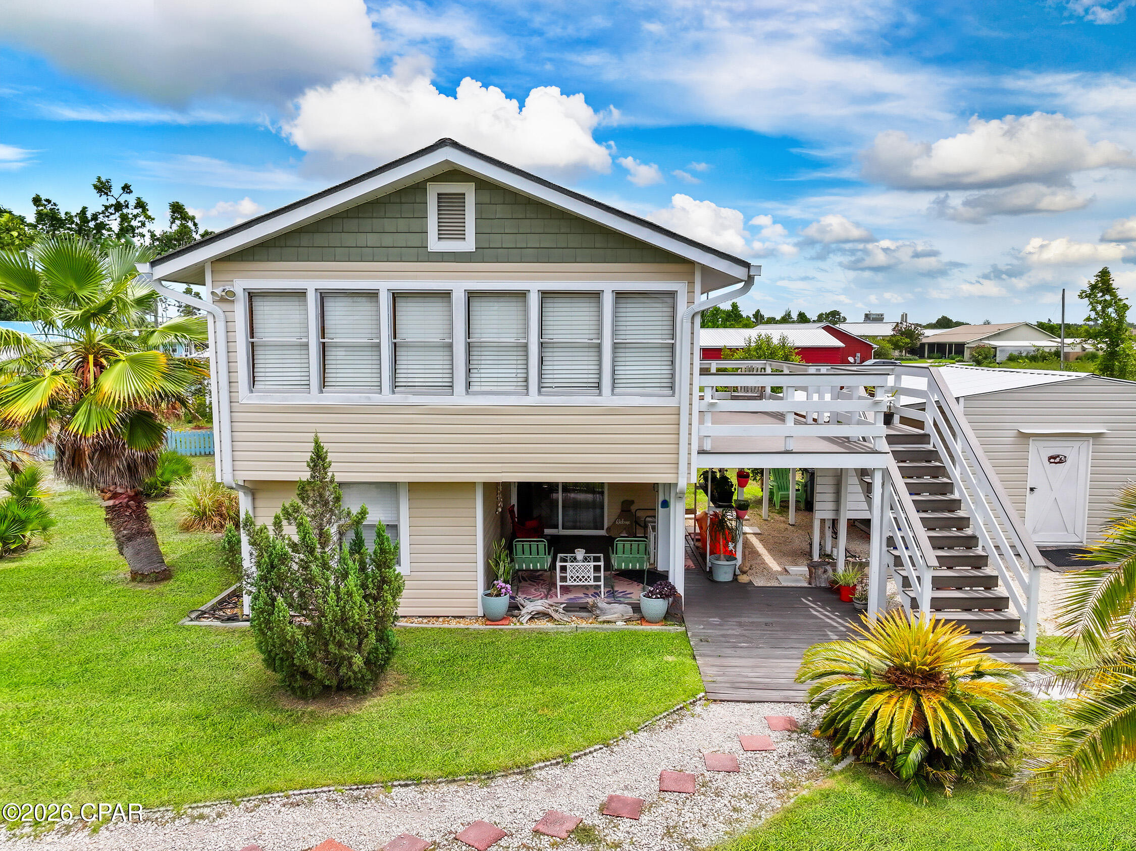 TWO FOR THE PRICE OF ONE! This property is equal parts investment and enjoyment. 

Welcome to 412 California Avenue--a rare opportunity in the heart of Mexico Beach offering two completely separate living spaces under one roof. Whether you're looking for a primary residence with rental income, a beach retreat for extended family, or an investment property with short or long-term rental potential, this one checks all the boxes.

A local vacation rental management company conservatively estimates average annual gross rental income at approximately $15,000 for the combined units. On the long-term rental market, each unit can command approximately $1,400/month. 

Located in desirable Flood Zone X--where flood insurance is not typically required by lenders--this home features a fully equipped upper residence with an open-concept living area, kitchen, spacious bedroom, full bath and soaring wood-accented ceilings that create a warm coastal retreat.

The lower level is completely independent with its own private entrance, kitchenette, living area, bedroom and full bath, making it ideal for guests, multi-generational living or generating rental income while maintaining privacy for everyone.

Outside, the Mexico Beach lifestyle truly comes to life. Start your mornings with coffee on the expansive upper deck, spend afternoons relaxing beneath the covered patio, and enjoy the beautifully landscaped yard filled with mature palms and plenty of room to entertain. 

The detached shed/workshop provides exceptional storage for beach gear, fishing equipment and all the toys that come with living at the beach.
Best of all, you're just a short golf cart ride or bike ride from Mexico Beach's sugar-white sand, Gulf waters, locally owned restaurants, marina, parks and unforgettable sunsets.

Being sold mostly furnished, this is a turnkey opportunity to begin enjoying the Forgotten Coast lifestyle from day one--whether you're moving in full-time, creating a family beach getaway or adding a versatile income-producing property to your portfolio.