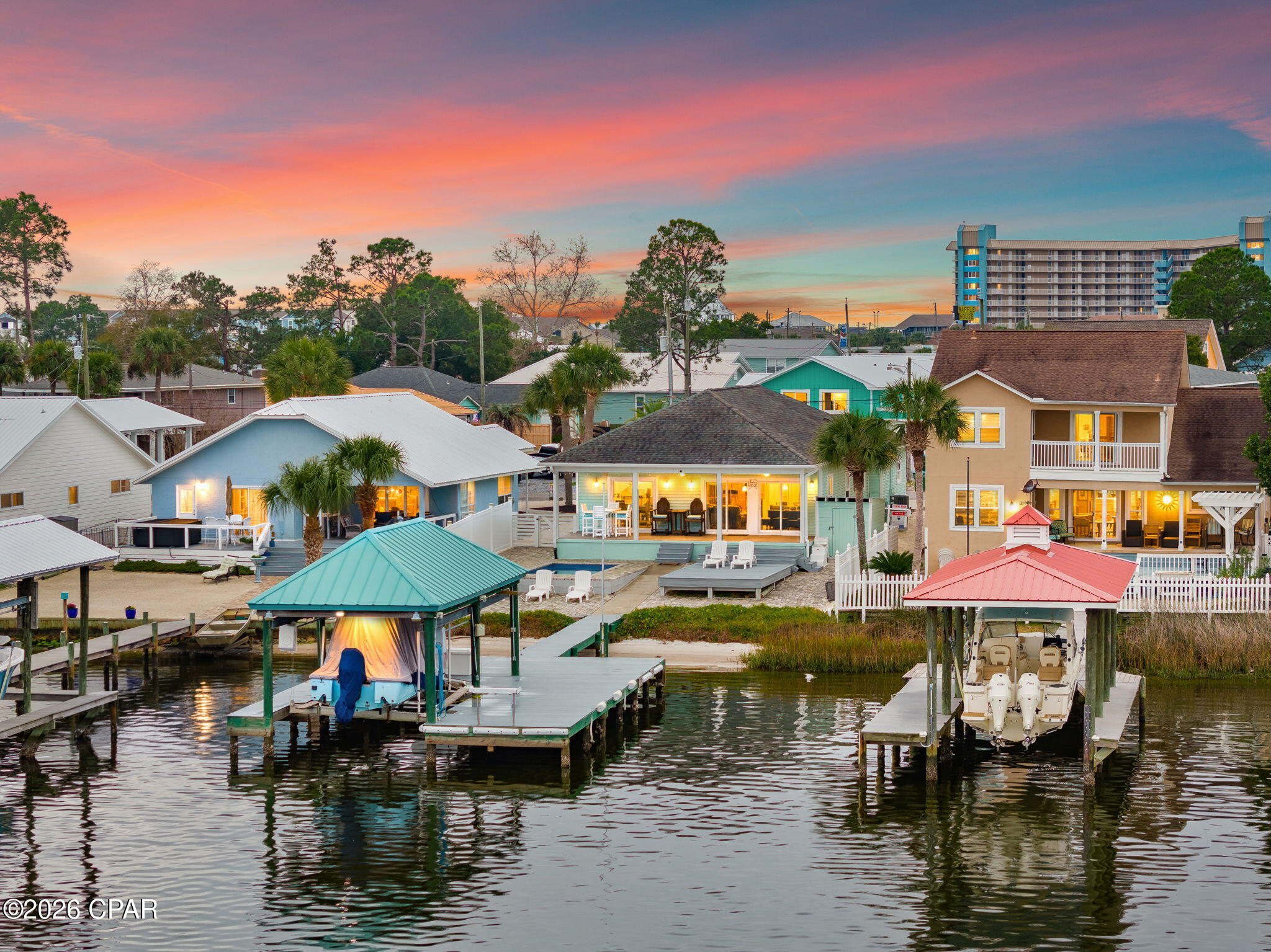 Set directly on Grand Lagoon, this thoughtfully maintained three-bedroom, two-bath residence offers 1,537 square feet of waterfront living with sweeping views and direct boating access to St. Andrew Bay and the Gulf of Mexico. 

Designed to make the most of its setting, the open-concept interior is filled with natural light and oriented toward the water, creating a seamless connection between the living spaces and the lagoon beyond.

Outdoor living is central to the property. Trex decking extends to a covered dock with a boat lift, while three nearby boat launches add convenience for days on the water. A heated and cooled pool provides year-round enjoyment, complemented by a paver driveway and low-maintenance Bahama rock landscaping.

Located just minutes from the beach, the residence is equally suited as a primary home, coastal retreat or short-term rental investment. Furnishings are negotiable, offering the opportunity for a streamlined transition into the waterfront lifestyle. With a private pool, protected dockage and convenient access to both the bay and Gulf, this Grand Lagoon residence presents an uncommon combination of comfort, recreation and location.

All information and measurements are deemed reliable but are not guaranteed. Buyers should independently verify all details.