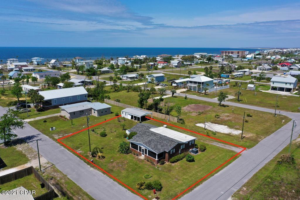 Brick home located only a couple of blocks from dedicated beach in Mexico Beach. Home sits on a large quiet corner lot. Neighborhood is quiet and makes for great golf cart rides. Newly remodeled with brand new appliances, flooring,paint, kitchen cabinets and counter tops along with new fresh tile in guest bathroom. Large screened in front porch makes for a great space to enjoy the coastal breeze and entertain guest.Tons of parking for RV's or boats and trailer. Lot is large enough to split to sell or build separate home as long as permits allow. No HOA fees and flood insurance not required