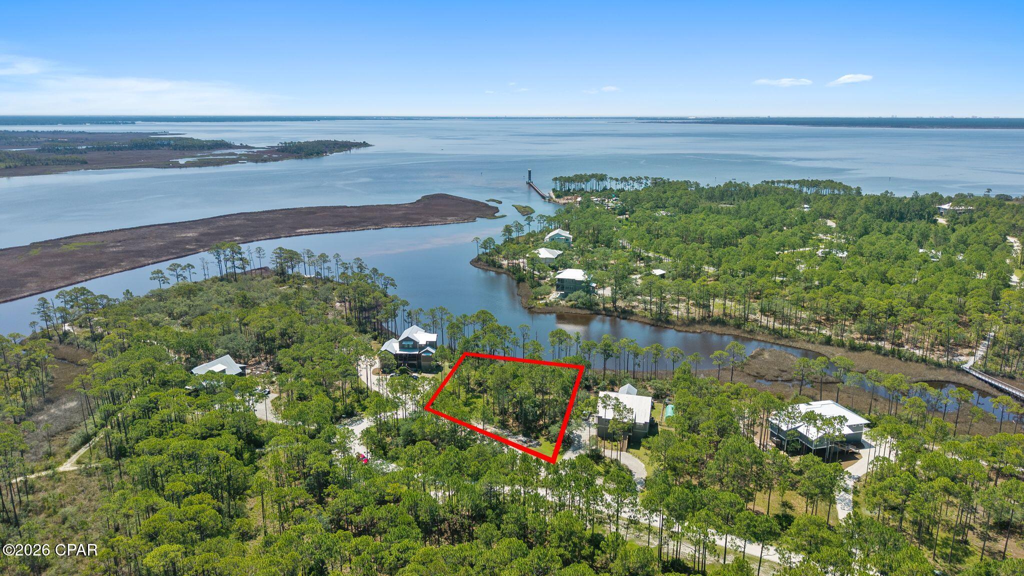 Build your dream home in the beautiful, gated community of RiverCamps on Crooked Creek! This large, secluded homesite offers the perfect blend of privacy and convenience, located just off Highway 79--only minutes from Northwest Florida Beaches International Airport (ECP), the white-sand beaches of Panama City Beach, Pier Park, dining, shopping, and entertainment.

Surrounded by nature, this peaceful lot is tucked within one of the area's most unique waterfront communities, where over 1,500 acres of preserved woodlands, waterways, and wildlife create an unmatched coastal lifestyle. RiverCamps borders Crooked Creek, West Bay, and the Intracoastal Waterway, offering incredible opportunities for boating, fishing, kayaking, paddleboarding, hiking, and birdwatching. Residents enjoy resort-style amenities including a community pool, boat launch, day docks, boat storage, miles of scenic boardwalks and nature trails, pickleball, and a waterfront campground. A new fitness center is currently under construction, adding even more value to this exceptional community.

As an added bonus, this property includes TWO professionally designed sets of house plans, giving you a head start on creating your custom coastal retreat.

Whether you're looking for a full-time residence or a private getaway, this homesite offers the rare opportunity to enjoy the serenity of nature without sacrificing convenience. Come experience why RiverCamps is one of Panama City Beach's best-kept secrets!