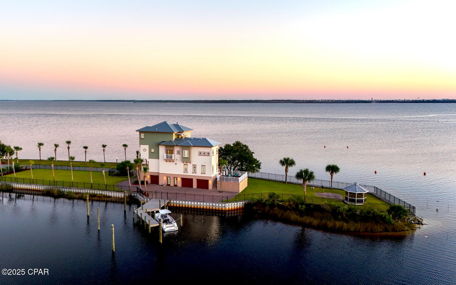 Landmaxxing at its finest! Welcome to 34 Palms A One-of-a-kind Waterfront Oasis Redefining Luxury Coastal Living. Experience the pinnacle of Florida waterfront living at 6701 Yacht Club Drive, a remarkable 0.83-acre peninsula estate with 360 panoramic bay views and endless adventure come together. Perfectly positioned with water on all sides, this 4-bedroom, 5-bath, 4,125-square-foot home captures the essence of the Florida boating lifestyle where every sunrise, sunset, and gentle breeze reminds you that you've arrived somewhere truly special. A Boater's Paradise: With direct Gulf access from your backyard, 34 Palms is your personal gateway to the open water. Offering both a private dock and an additional community boat slip, this property was designed for those who love to live life on the water. The calm bay setting is also perfect for kayaking, paddle-boarding, and jet skiing, all from the comfort of your home.
Outdoor Living at Its Finest: Every inch of the estate was designed to celebrate outdoor living. Expansive decks and palm-lined walkways lead to multiple lounging areas ideal for entertaining or simply soaking in the serenity. Surrounded by lush tropical landscaping, this private oasis allows you to fish, paddle, or relax in complete tranquility   all while enjoying breathtaking views unique to its peninsula setting.

Elegant Interiors & Inspired Design: Inside, natural light pours through floor-to-ceiling windows, illuminating open living spaces that seamlessly blend indoor and outdoor living. The heart of the home a bright, modern kitchen and inviting living area is perfect for both gatherings and quiet reflection, offering stunning water views from every angle.

Luxurious Private Retreats: The primary master suite, perched on the top floor, provides a peaceful sanctuary with a private balcony, outdoor shower, and sweeping sunrise-to-sunset views. A third-floor guest suite offers its own ensuite bath and walk-in closet, while two additional bedrooms share a charming Jack-and-Jill bath ideal for family or guests. A three-car garage with an office or workshop space completes the thoughtful layout.

Key Features Include: 

-0.83-acre peninsula lot with water on all sides.
-Over 500+ of Waterfront.
-Private dock plus community marina boat slip
-Direct Gulf of Mexico access for boating and fishing.
-Expansive 4,125 sq. ft. of light-filled living space.
-Multiple decks and outdoor entertaining areas
-Lush tropical landscaping.
-Waterfront Gazebo with Private Beach. 
-Largest lot in East Bay PreserveMore than a home. 

34 Palms is a lifestyle one defined by endless horizons, outdoor adventure, and effortless elegance. Discover unparalleled waterfront living where every day feels like a getaway.

Schedule your private tour today and experience how 34 Palms redefines luxury coastal living.