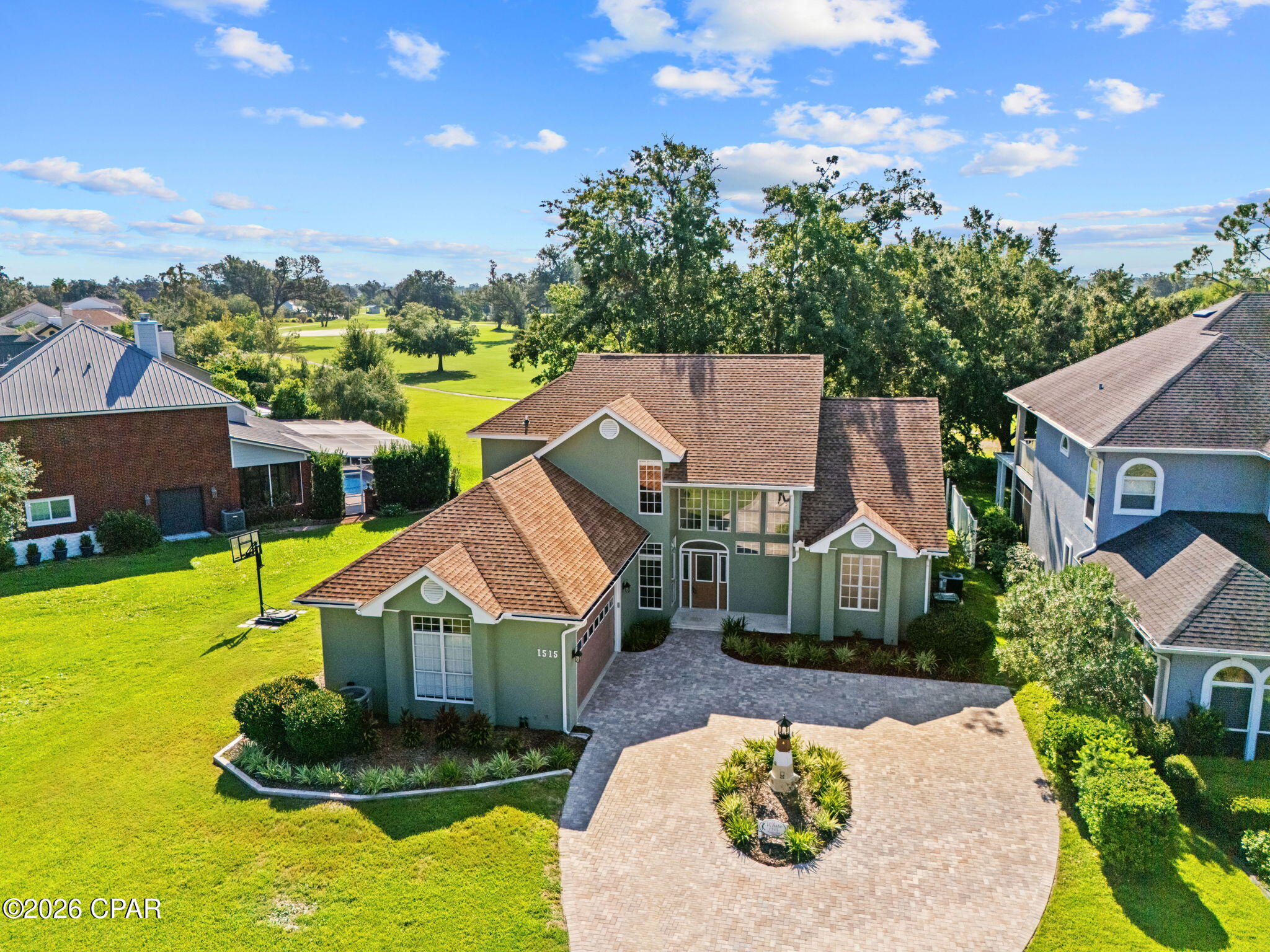 Welcome to this beautifully updated 4-bedroom, 2.5-bathroom home in the desirable Panama Country Club community, ideally positioned overlooking the 12th hole of the golf course. Offering a blend of thoughtful updates, functional living spaces, and resort-style outdoor living, this home is ready to enjoy.

Step inside to an inviting open floor plan that seamlessly connects the living room, kitchen, and dining area. The living room features a vaulted ceiling and entertainment center, creating an ideal space for both everyday living and entertaining. The kitchen has been refreshed with an updated tile backsplash, while custom cabinetry has been added in the living room. Plank tile flooring flows throughout the downstairs living areas, complemented by new carpet in the primary bedroom.

The main-floor primary suite offers a private retreat with a large walk-in closet and a beautifully remodeled bathroom featuring a tile shower, custom cabinetry, granite countertops, two vanities, a separate spa tub, and tile flooring. The upstairs bathroom has also been updated with new tile flooring.

Numerous improvements throughout the home provide both style and peace of mind. Recent updates include resealed and painted exterior stucco, resealed windows, fresh interior paint, replacement glass in six windows and updated glass in the front door, new light fixtures and hardware throughout, custom remote-controlled blinds and shades, and a whole-house surge protection system. The home also features two HVAC systems and two water heaters for year-round comfort and convenience. The HVAC serving the primary side of the home was replaced in August 2025.

The home's exterior has been extensively enhanced as well. Enjoy the golf course views from the new screened-in back porch with panoramic screens, featuring a polyaspartic-coated floor. The fenced backyard offers privacy while the updated front and rear landscape beds add curb appeal. A brick paver driveway and travertine front porch were added in May 2026, while the garage received a new belt system and motor, along with a motor/lift system for the golf cart door.

Additional recent improvements include removal of the chimney and replacement of a large portion of the south-facing roof, installation of a Culligan whole-house water filtration system with Reverse Osmosis at the kitchen sink and refrigerator, and polyaspartic coating in the garage and back porch.

The large unfinished attic provides abundant storage for seasonal items and more. With golf course views, a fenced yard, screened outdoor living, a spacious open interior, and an extensive list of recent improvements, this Panama Country Club home offers a combination of comfort, functionality, and location that is hard to overlook.

Buyer to verify all information deemed important.