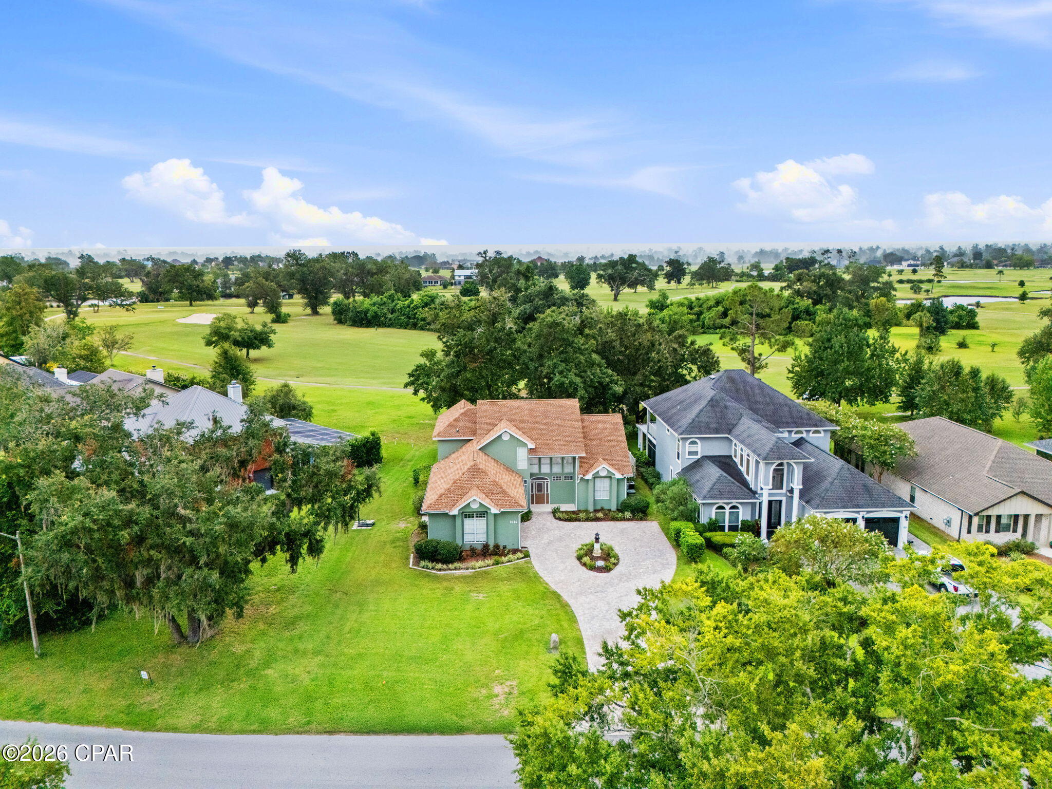 Welcome to this beautifully updated 4-bedroom, 2.5-bathroom home in the desirable Panama Country Club community, ideally positioned overlooking the 12th hole of the golf course. Offering a blend of thoughtful updates, functional living spaces, and resort-style outdoor living, this home is ready to enjoy.

Step inside to an inviting open floor plan that seamlessly connects the living room, kitchen, and dining area. The living room features a vaulted ceiling and entertainment center, creating an ideal space for both everyday living and entertaining. The kitchen has been refreshed with an updated tile backsplash, while custom cabinetry has been added in the living room. Plank tile flooring flows throughout the downstairs living areas, complemented by new carpet in the primary bedroom.

The main-floor primary suite offers a private retreat with a large walk-in closet and a beautifully remodeled bathroom featuring a tile shower, custom cabinetry, granite countertops, two vanities, a separate spa tub, and tile flooring. The upstairs bathroom has also been updated with new tile flooring.

Numerous improvements throughout the home provide both style and peace of mind. Recent updates include resealed and painted exterior stucco, resealed windows, fresh interior paint, replacement glass in six windows and updated glass in the front door, new light fixtures and hardware throughout, custom remote-controlled blinds and shades, and a whole-house surge protection system. The home also features two HVAC systems and two water heaters for year-round comfort and convenience. The HVAC serving the primary side of the home was replaced in August 2025.

The home's exterior has been extensively enhanced as well. Enjoy the golf course views from the new screened-in back porch with panoramic screens, featuring a polyaspartic-coated floor. The fenced backyard offers privacy while the updated front and rear landscape beds add curb appeal. A brick paver driveway and travertine front porch were added in May 2026, while the garage received a new belt system and motor, along with a motor/lift system for the golf cart door.

Additional recent improvements include removal of the chimney and replacement of a large portion of the south-facing roof, installation of a Culligan whole-house water filtration system with Reverse Osmosis at the kitchen sink and refrigerator, and polyaspartic coating in the garage and back porch.

The large unfinished attic provides abundant storage for seasonal items and more. With golf course views, a fenced yard, screened outdoor living, a spacious open interior, and an extensive list of recent improvements, this Panama Country Club home offers a combination of comfort, functionality, and location that is hard to overlook.

Buyer to verify all information deemed important.