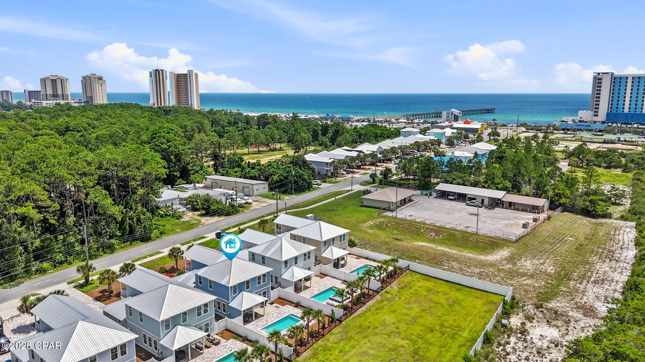 BEACH WITHIN REACH! Short-Term Rental Pool Home Priced to Sell! Just a short stroll to the sugar-white sands of Panama City Beach, the MB Miller County Pier, restaurants, and attractions, this beautifully furnished new construction coastal retreat offers the perfect combination of luxury, location, and income potential. Rental history available with so much potential, this six-bedroom, four-bath home is an exceptional opportunity for investors or those searching for the ultimate beach getaway.

The backyard is your own private resort, featuring a 24' x 10' gunite pool surrounded by elegant pavers, a fully fenced yard, and an outdoor shower--perfect for rinsing off after a day at the beach. There's plenty of room for lounge chairs, entertaining, grilling, and enjoying Florida's sunshine.

Inside, the coastal modern design is both stylish and inviting. The open-concept living area is designed for gathering, complete with a spacious family room, oversized flat-screen TV, and a chef-inspired kitchen featuring quartz countertops, stainless steel appliances, a large breakfast bar, and a generous dining area. Everything is move-in ready, including the washer and dryer.

The thoughtfully designed floor plan offers a spacious primary suite on the main level overlooking the pool, along with a second guest bedroom and full bath. Upstairs, you'll find another luxurious king suite with a private ensuite bath, a queen bedroom with its own balcony, an oversized custom bunk room that comfortably sleeps six, and a sixth bedroom currently configured as a media/playroom with a sleeper sofa and large-screen TV, providing flexible space for additional guests.

Additional features include a garage for storing beach gear and bikes, ample parking, quality coastal furnishings throughout, and the home is being sold fully furnished, making it truly turnkey for immediate enjoyment or rental income.

Whether you're looking for a high-performing vacation rental, second home, or full-time coastal residence, this exceptional property delivers the beach lifestyle buyers are searching for. Beach within reach, luxury at your doorstep, and income potential that's hard to beat!