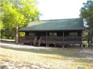 CUSTOM BUILT 3 BEDROOM 2 BATH HOME ON ALMOST 5 ACRES. OPEN FLOOR PLAN THROUGHOUT HOME, OVERSIZED COVERED DECK AND FRONT PORCH IS LENGTH OF FRONT OF HOME AND SET UP FOR HOT TUB. BEAUTIFUL GAS FIREPLACE WITH REMOTE START AND 4 REMOTE CEILING FANS IN LIVING AREA, 25X10 COVERED BACK DECK HAS GAS LINE HOOK UP FOR GRILL.KITCHEN CABINETS ARE CUSTOM BUILT AND ALSO INCLUDES LARGE ISLAND.MASTER ON MAIN, LARGE LAUNDRY ROOM ON MAIN, 2 SPACIOUS BEDROOMS AND FULL BATH UPSTAIRS. DOUBLE CARPORT WITH WORKSHOP.PLENTY OF EXTRA PARKING ON OVERSIZED CONCRETE PAD PROPERTY IS FENCED ON THREE SIDES AND HAS THREE GOOD WELLS. ABOVE GROUND SWIMMING POOL.MATURE HARDWOODS THROUGHOUT PROPERTY BUT NOT WOODED.HOME IS IMMACULATE OWNER BUILT AND NO CORNERS WERE CUT.WHEN YOU WALK IN HOME YOU WILL BE SOLD IT LACKS