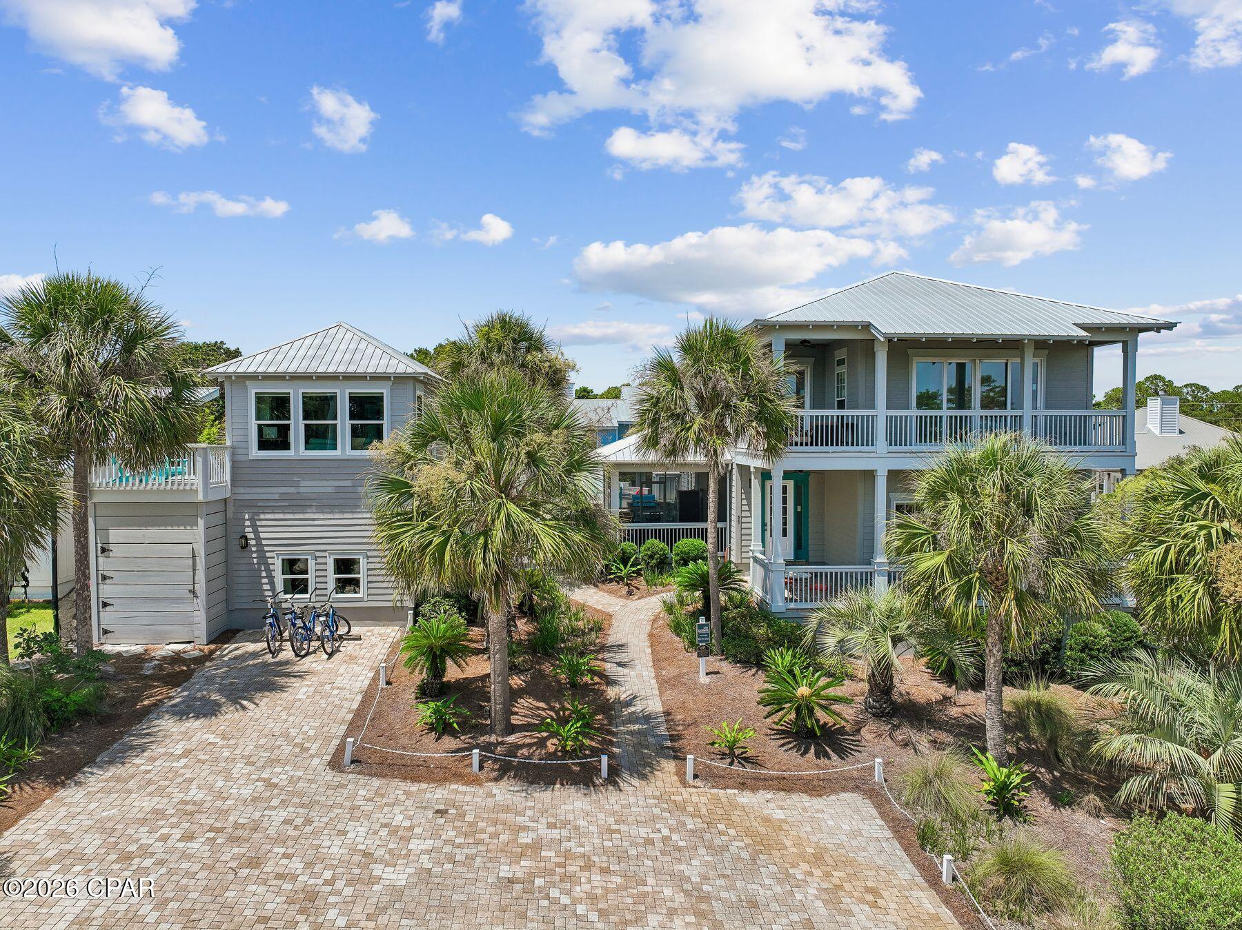 Just a short walk from the sugar-white sands of the Gulf, this exceptional six-bedroom Blue Mountain Beach compound offers projected annual rental income up to $200,000, an oversized resort-style pool, two detached guest suites, and exceptional outdoor living -- all situated on a rare .24-acre homesite.

Thoughtfully designed for entertaining and hosting family and friends, the property offers four bedrooms in the main residence along with two detached guest suites, creating a level of privacy and flexibility rarely found along Scenic Highway 30A. Whether gathering under one roof or providing guests with their own private retreat, the versatile floor plan comfortably accommodates every occasion. Situated on a generous .24-acre homesite, the property offers an exceptional amount of outdoor space this close to the gulf. The expansive lot provides room for an oversized resort-style pool, detached guest accommodations, lush tropical landscaping, and multiple outdoor gathering areas while maintaining a sense of privacy that is increasingly difficult to find in Blue Mountain Beach.

The resort-style backyard is where this home truly shines. Centered around an expansive private pool -- significantly larger than those typically found in the area -- the outdoor living experience is elevated by a built-in grilling station, fire feature, screened porch, and multiple spaces to dine, relax, and entertain. Surrounded by mature coastal landscaping, the setting offers the feel of a private luxury resort just moments from the beach. 

Inside, the main residence features bright coastal interiors, an open-concept floor plan, and inviting covered porches that embrace the relaxed Blue Mountain Beach lifestyle. The spacious living, dining, and kitchen areas create a natural gathering place for family and guests, while the thoughtful layout balances comfortable everyday living with effortless entertaining. 

Adding to the property's appeal is a detached two-story guest retreat designed for both privacy and entertainment. The pool-level guest suite offers sleeping accommodations and a dedicated lounge with an arcade game, while the upper-level suite features a private bedroom, a full bath, a living area, a kitchenette and a covered porch. Together, these separate guest accommodations create a rare level of flexibility for hosting family and friends or enhancing the property's rental appeal. 

Located just moments from beach access and minutes from Blue Mountain Beach's favorite restaurants, local shops, and the scenic 30A bike path, this exceptional property delivers a rare combination of beach proximity, resort-style amenities, generous outdoor living, and flexible guest accommodations. From the oversized pool and outdoor entertaining spaces to the detached guest suites, projected rental income up to $200,000 annually, and rare .24-acre homesite, this is the kind of Blue Mountain Beach property that rarely becomes available.