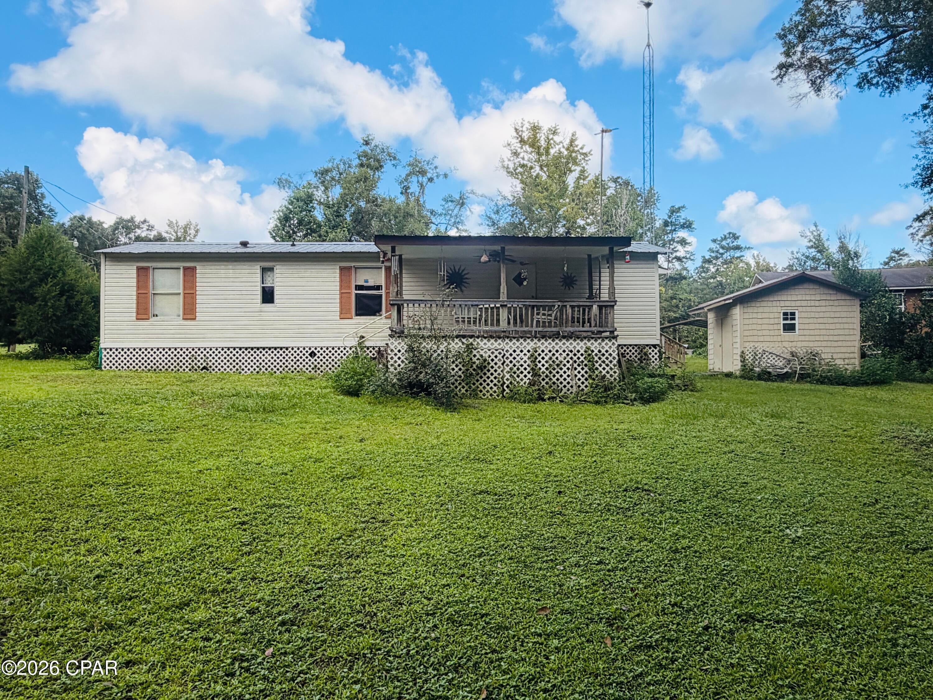 Calling all outdoor enthusiasts! Tucked away at the end of Ridgecrest Lane, this 2-bedroom, 1-bath property offers a quiet retreat with easy access to some of Northwest Florida's best hunting, fishing, boating, and beaches.

Located within the Bryant's Landing Hunting and Fishing Utility Cooperative, you'll enjoy access to a concrete boat landing on the Chipola River, a shared fish-cleaning house, and the convenience of water and sewer service provided through the cooperative for an annual fee. The property also features a spacious covered porch, storage shed, and covered boat storage--everything you need for your next outdoor adventure.

Enjoy the peaceful, tucked-away setting while still being conveniently located approximately 20 minutes from Port St. Joe and 25 minutes from Mexico Beach. Spend the morning fishing the Chipola, the afternoon at the beach, and the evening relaxing on your porch!

Whether you're looking for a full-time home, weekend getaway, hunting and fishing retreat, or simply a quiet place close to the river and coast, 129 Ridgecrest Lane is ready for you. Bring the boat, fishing poles, and outdoor gear--this is Florida living for those who'd rather be outside!

BUYER TO VERIFY ALL MEASUREMENTS, IF IMPORTANT.  ASSOCIATION FEES COVER ANNUAL WATER AND SEWER COSTS.