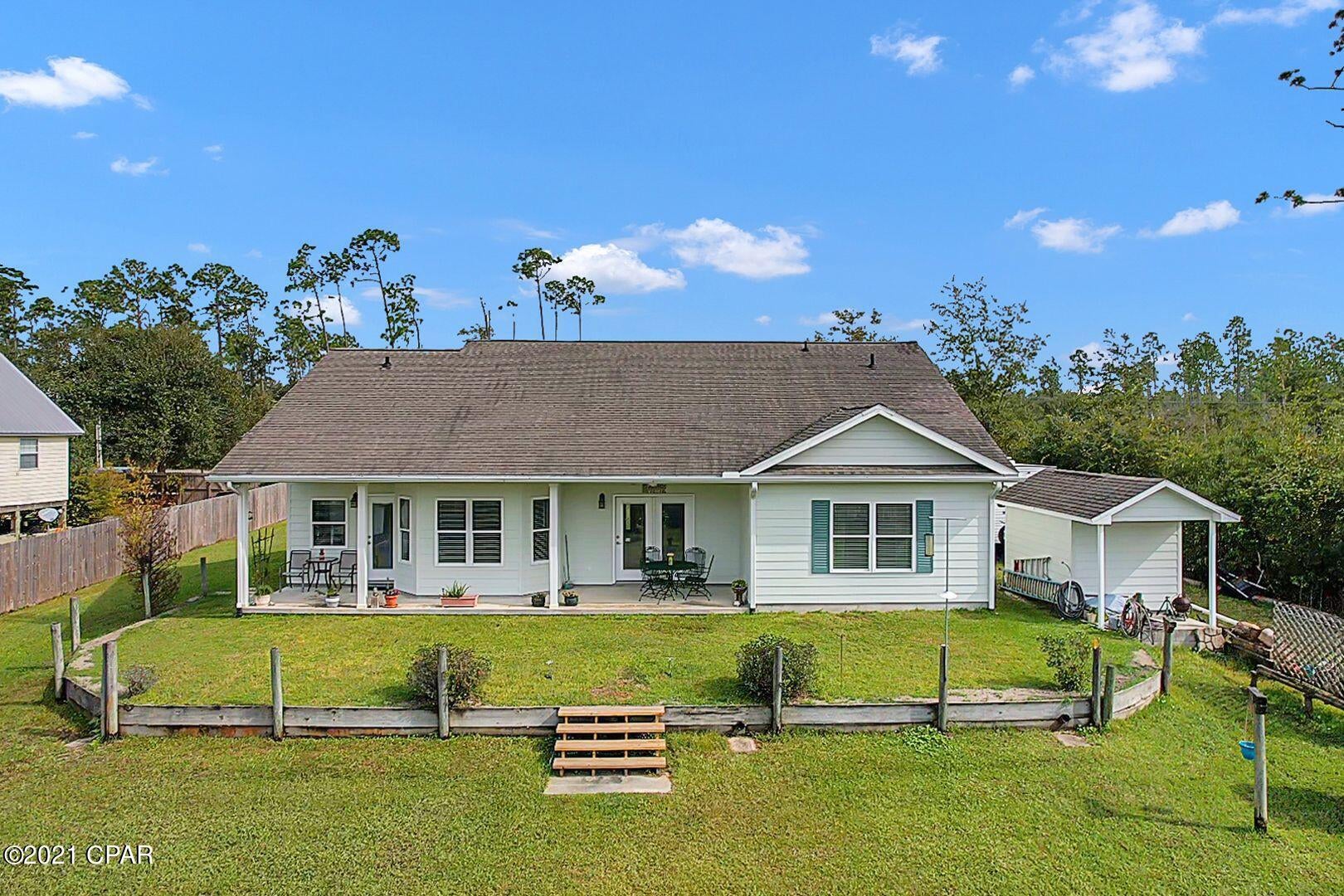 Under Contract-Taking Backups. Beautiful Waterfront Dream home. Enjoy the relaxing view of deep water Wetappo Creek from the large porch, or board your boat from the private 30' x 10' dock and cruise to the open waters of the gulf.  Picture yourself in paradise! This great home has: 9' ceilings, 2x6'' walls construction, three tone paint, carpet, tile, two porches, The master bathroom features, shower & Jacuzzi jetted tub, walk-in closet, double vanities, and a separate toilet room. The kitchen has recessed lighting, tiled backsplash, hardwood cabinets with plenty of storage space, garbage disposal, glass-top built-in range, and microwave. Double garage with openers and epoxy sealed floor. The home features a deep well and septic tank. Storage shed for housing lawn and garden equipment. Whether you love fishing, sailing, power boating, or simply relaxing, this beautiful home offers lots of opportunities. All measurements are approx. If important, please verify.