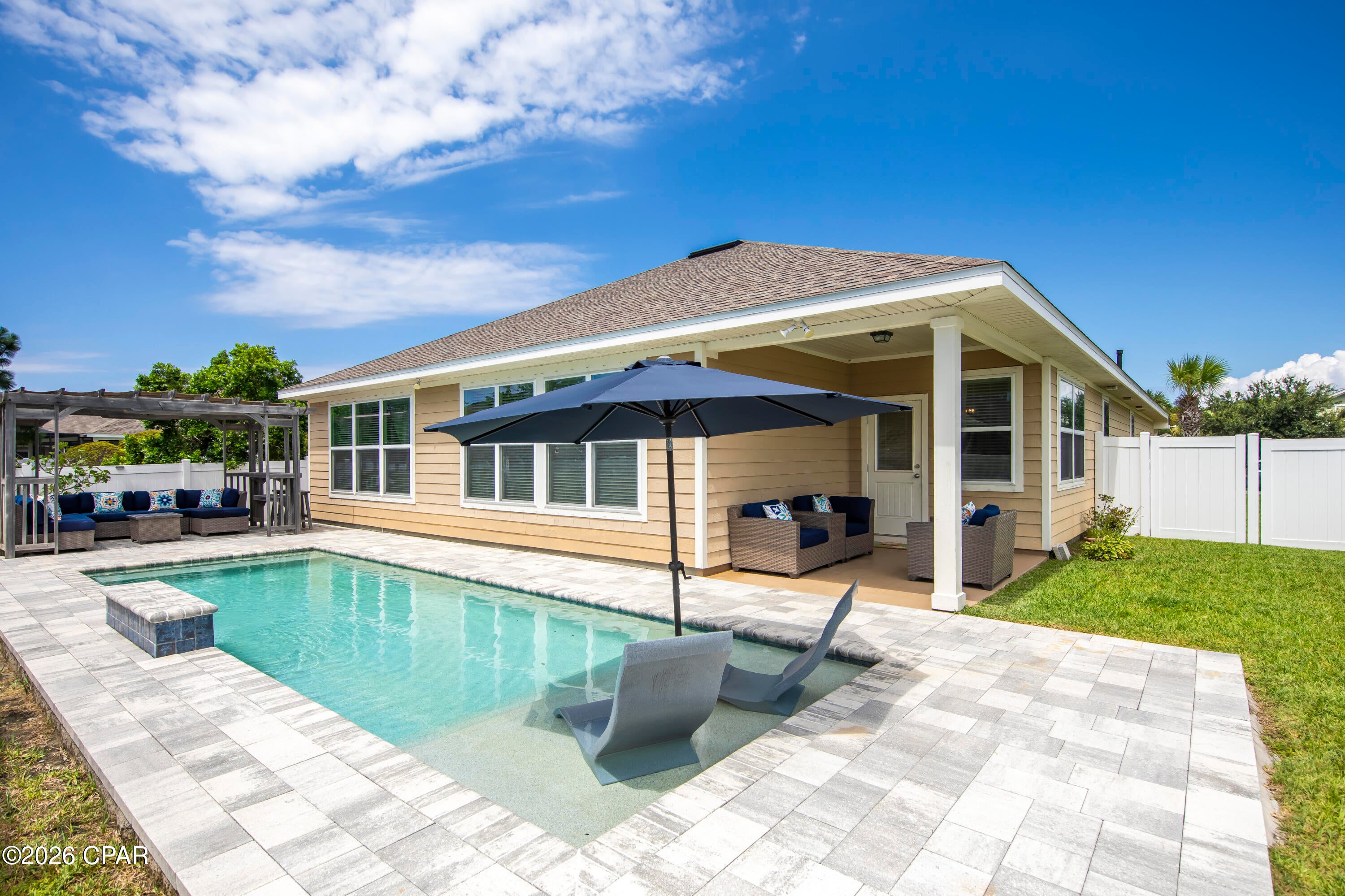 Experience refined coastal living in one of Panama City Beaches most sought-after communities. This beautifully customized Breakfast Point residence offers the perfect blend of elegance, comfort, and resort-style outdoor living. Originally designed as a four-bedroom, three bath home, this thoughtfully reimagined floor plan now features dual primary suites, created by combining two secondary bedrooms into one expansive MIL suite. The result is an ideal layout for multi-generational living, guests, or anyone who appreciates exceptional space and privacy. A 3rd bedroom and a flex room, currently being used as the 4th bedroom, is conveniently split from the MIL suite. Just past the bedrooms, there is a formal dining room just before entering the living area.  The open-concept living area, effortlessly connects the kitchen with a large island, dining area, and family room, creating an inviting atmosphere perfect for entertaining or everyday living. Expansive windows fill the home with natural light while providing beautiful views of the spectacular backyard. Step outside and discover your own private resort. The professionally designed outdoor living space showcases a stunning custom swimming pool with an inviting sun shelf, elegant paver decking and a beautifully appointed covered cabana complete with lounge seating-the perfect setting for relaxing afternoons, sunset cocktails, or unforgettable evenings under the Florida sky. Privacy fencing and lush landscaping create a tranquil retreat that feels like a luxury vacation every day. From the moment you arrive, the home's exceptional curb appeal makes a lasting impression with it's welcoming front porch, manicured tropical landscaping, and timeless Craftsman-inspired design. This home is ideally situated close to the entrance of the Breakfast Point Academy, with a convenient access to Arnold High School via neighborhood trails. The neighborhood amenities include playgrounds, scenic walking trails with  beautifully maintained green spaces. Just minutes from Panama City Beaches world-famous sugar-white beaches, Pier Park, championship golf, waterfront dining, shopping and entertainment, this exceptional home offers the perfect combination of comfort, location, and lifestyle. Schedule a showing today, you won't want to miss this one!