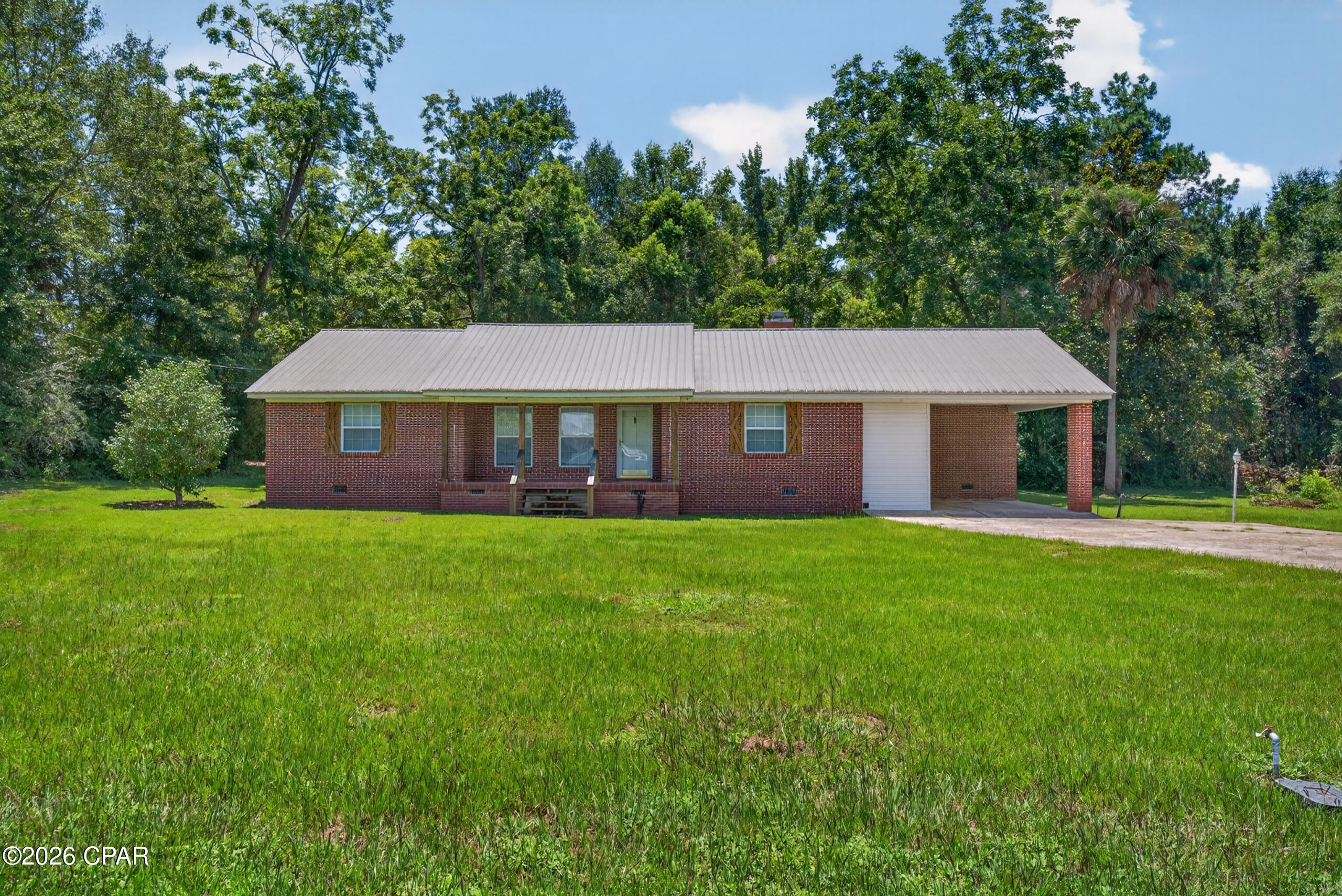 Beautiful brick home within the city limits of Graceville, just half a mile from Florida Baptist University! This spacious home features a desirable split floor plan with both a living room and family room. The family room offers a wood-burning fireplace, while the living room has a decorative fireplace perfect for an electric insert or candles.

The open kitchen flows into the family room and features tile countertops, with tongue-and-groove ceilings adding warmth and character to both spaces. Wood flooring is found throughout much of the home, while the family room has LVP with hardwood underneath. A formal dining area provides additional space for meals and gatherings. Please note, the kitchen does not currently include a stove.

Outside, enjoy a large covered back porch, outbuilding, carport, concrete driveway, and paved road frontage. Explore the 3D Home Tour for a closer look at the layout. Conveniently located near shopping, restaurants, schools, and other local amenities.