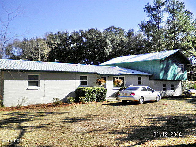 This large home has been completely remodeled, the main house is a 3/2.5 with tile and wood laminate, updated kitchen new paint,new drain-field installed in 2013 new well in 2005 (old well not capped would be good for irrigation) new metal roof in 2013, new wiring in 2006 new windows home and porch (Low E) in 2008 salt water solar heated in-ground pool with pool house. There is also a 1/1 with complete kitchen and and separate entrance for guest or rental unit. upstairs is a large open floor-plan nicely remodeled with a deck overlooking the pool. The complete property is fenced and the present owners have dogs. The pool is fenced, there is a nice sun-room with a view of the pool also, this home has a lot to offer and is just minutes from downtown, and a corner property. The carport will hold 3 cars easy with room for storage, there is water run to carport also, there are citrus and fruit plants, large oaks and natural woods with a wet weather pond on the property. This is a solid and well constructed home, call agent today to show this home.