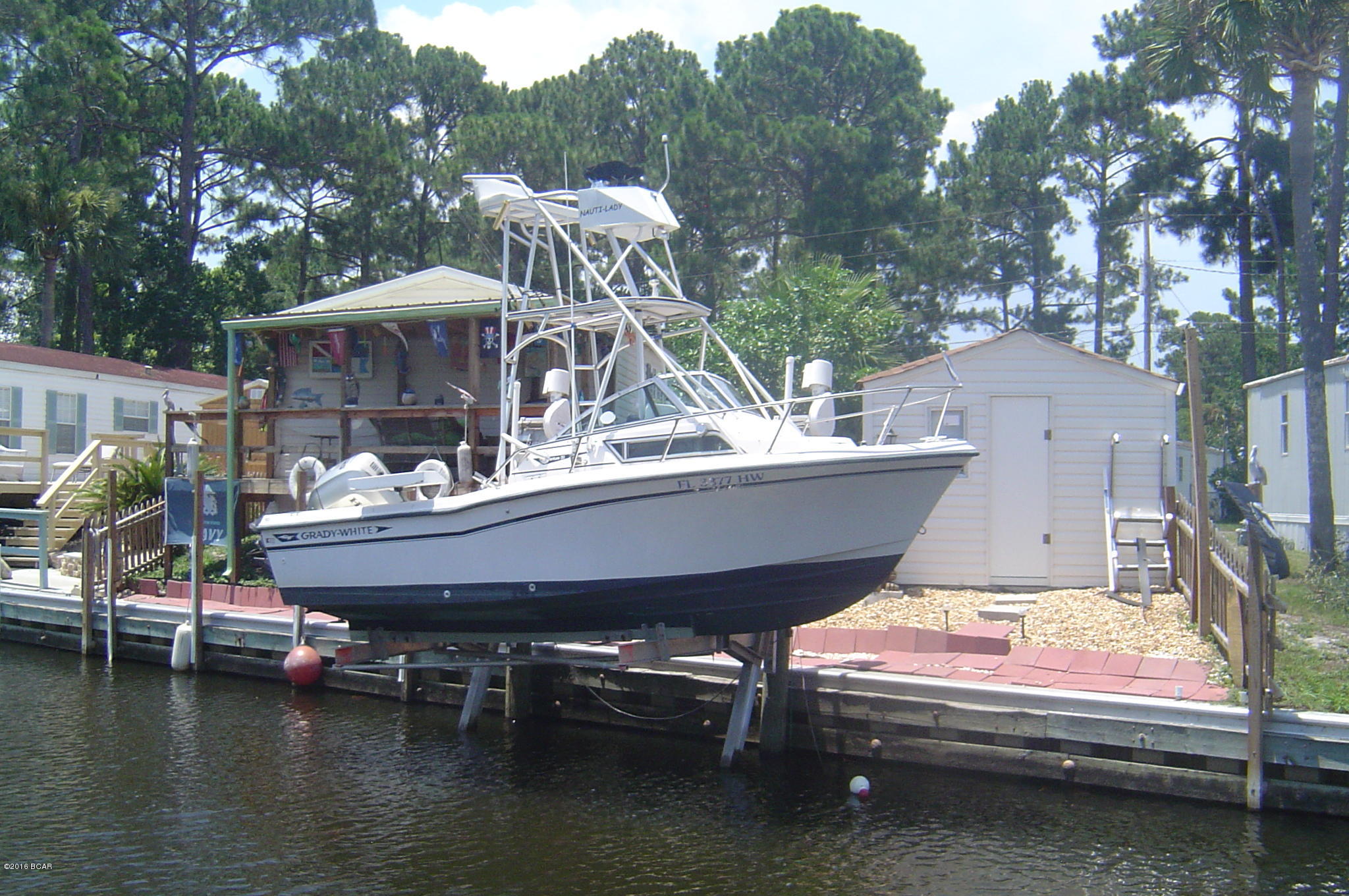 PERFECT''FISHERMANS GETTAWAY'' CANAL FRONT WITH A BOAT LIFT, DECKS, SWIM LADDER, CLEANING STATION <> DEEP WATER ACCESS <> FULLY FURNISHED AND READY TO GO <> TWO GOOD SIZE YARD BUILDINGS <> FRUITBEARING TREES <> THIS WELL KEPT, WELL CARED FOR WATERFRONT OOPORTUNITY WON'T LAST LONG <> MAKE AN APPOINTMENT FOR A PRIVATE SHOWING <> COMPOSIT SHEET PILE SEAWALL WITH 10'' METAL CAP.