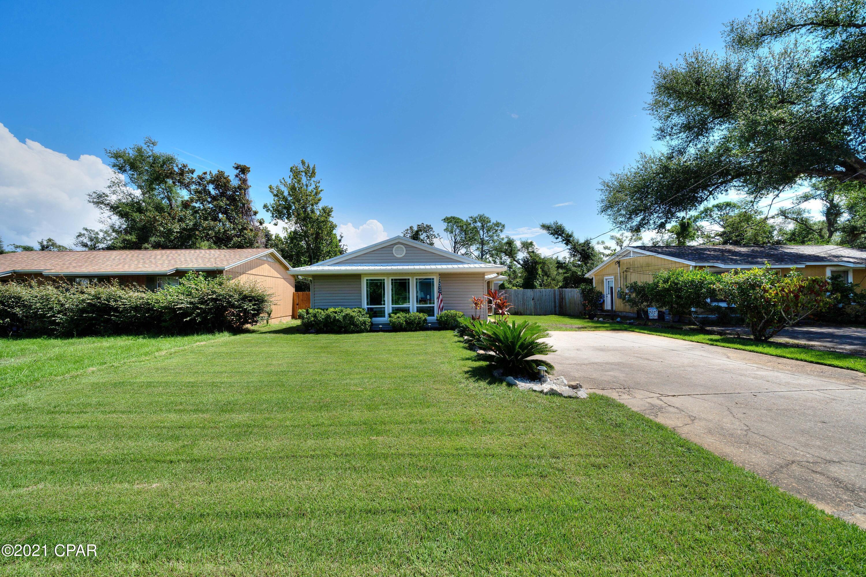 *Multiple Offers* *Highest and best due 9/12 5PM*. Open House 9/12 between 2 and 4. This gorgeous Florida cottage is move in ready is located just steps from beautiful St. Andrew's Bay. It is centrally  located in Panama City and is located just minutes from Panama City Beach. This little gem is 3 bdrm/ 2 bath with a beautifully landscaped in front and back with a privacy fence in back. The home has many updates throughout including flooring, new impact resistant hurricane grade windows throughout. The front door and side door have both been replaced as well. Shed in back yard was installed about 2 years ago in back yard and the patio and new gutters installed in 2021. All new plumbing pipes replaced in June from home to street and under house. Inside of house all repainted in 2018.