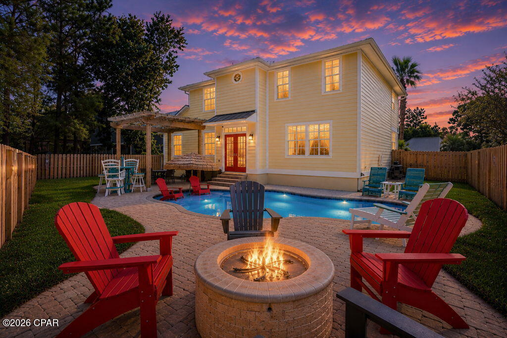 Less than half a mile from the beach, this fully furnished, extensively updated 4-bedroom, 3-bath Panama City Beach pool home delivers coastal comfort, smart-home convenience, and an exceptional outdoor entertaining space. Located at 805 Lyndell Way, this vacation rental property comes furnished with all-new furniture and smart TVs, making it an inviting choice for a beach getaway, rental investment, or primary residence. A brand-new six-seater golf cart can also convey with an acceptable offer!

Enjoy easy access to the Gulf's sugar-white sand beaches, Shipwreck Island Waterpark, shopping, and dining, with Pier Park approximately 3 miles away. Nearby attractions include Dolly Parton's Pirates Voyage Dinner & Show and Topgolf, putting favorite Panama City Beach entertainment options within easy reach.

The backyard centers around a new gunite saltwater pool with commercial-duty gas heating, an ozone system, and complete remote monitoring. A new patio and pergola create space for poolside dining and relaxing, while a custom stone gas firepit and new stainless steel grill with a permanent gas connection elevate outdoor entertaining. New fencing, sod, landscaping, gutters, and runoff drains complement the exterior improvements. A new irrigation system includes smart controls and all-new irrigation plumbing.

Inside, the kitchen and all three bathrooms feature new cabinets, countertops, backsplashes, sinks, and faucets. Additional improvements include new toilets in every bathroom, updated kitchen and bathroom plumbing and shutoff valves, all-new appliances, and a new commercial washer and dryer. New living room flooring, new carpet upstairs and in all bedrooms, new light fixtures and ceiling fans, and fresh paint throughout the interior and exterior complete the refreshed look.

Major system upgrades include two new HVAC systems with new indoor and outdoor units and smart thermostats, a completely new exterior electrical service panel with surge protectors and a new meter base, and an all-new sewer line. A new EV charging station, smart locks, camera system, and new garage door motor with smart remote operation add everyday convenience and remote management capabilities. Additional updates include new exterior lighting, epoxy-coated porch and garage floors, and new wired smoke detectors and exit lights.

With extensive improvements inside and out, all-new furnishings, and a private heated saltwater pool, 805 Lyndell Way brings together the features buyers seek in a Panama City Beach vacation home or furnished rental property.