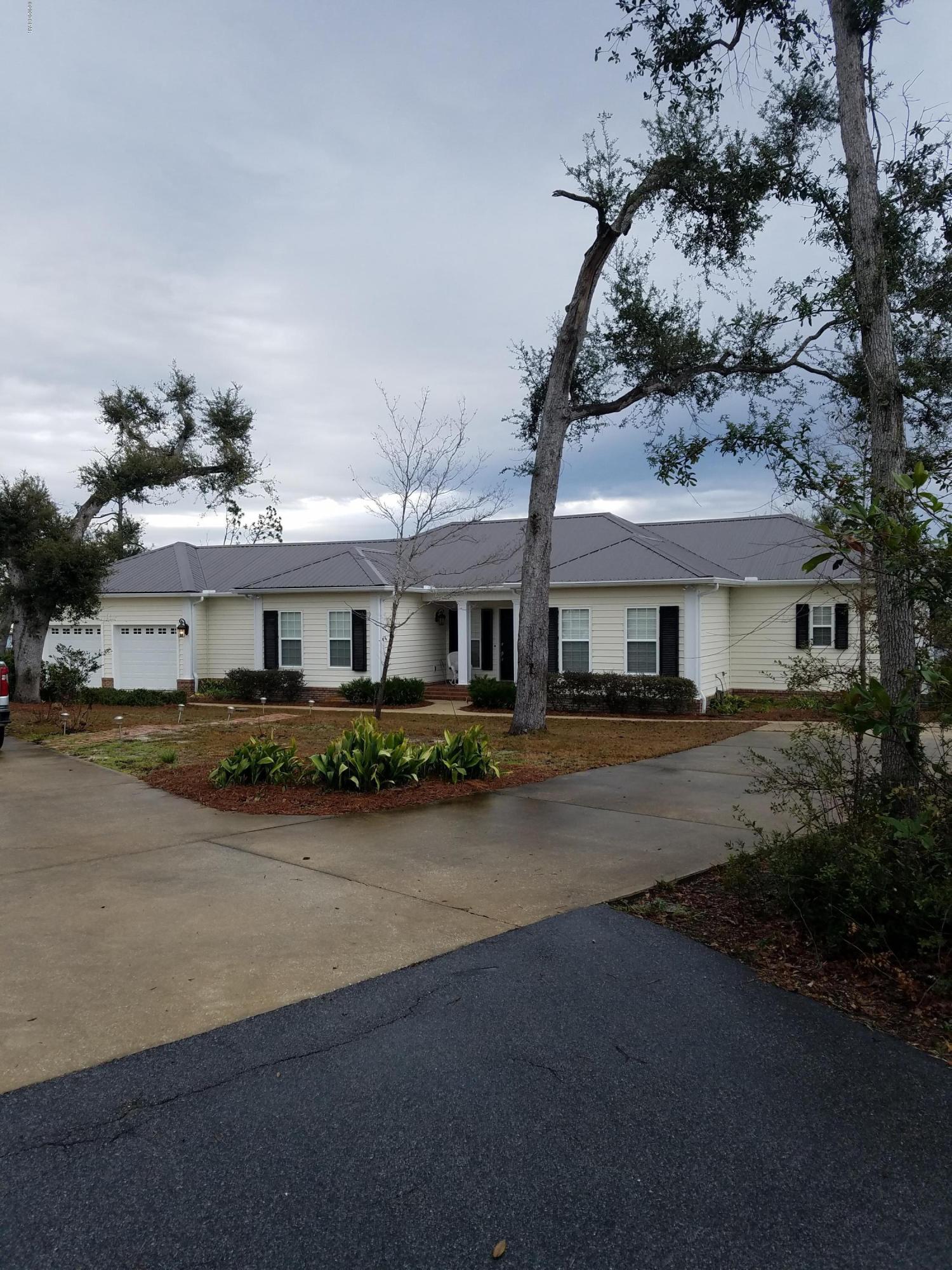 You must see this custom built 3786 sq ft. house, 2578 sq ft. is heat and cooled. Sit in the large screen porch outside the master bedroom overlooking the Bay and dock. This beautiful home has a large kitchen with breakfast bar. From the kitchen you have an open view into the dinning and living area. There is a large utility room with a good size storage closet across the hall. From here you can go to the over-sized 2 car garage or the other 2 bedrooms. Outside for your fun and enjoyment you can swim in the screened in pool or go play ping pong and pool in the game room.