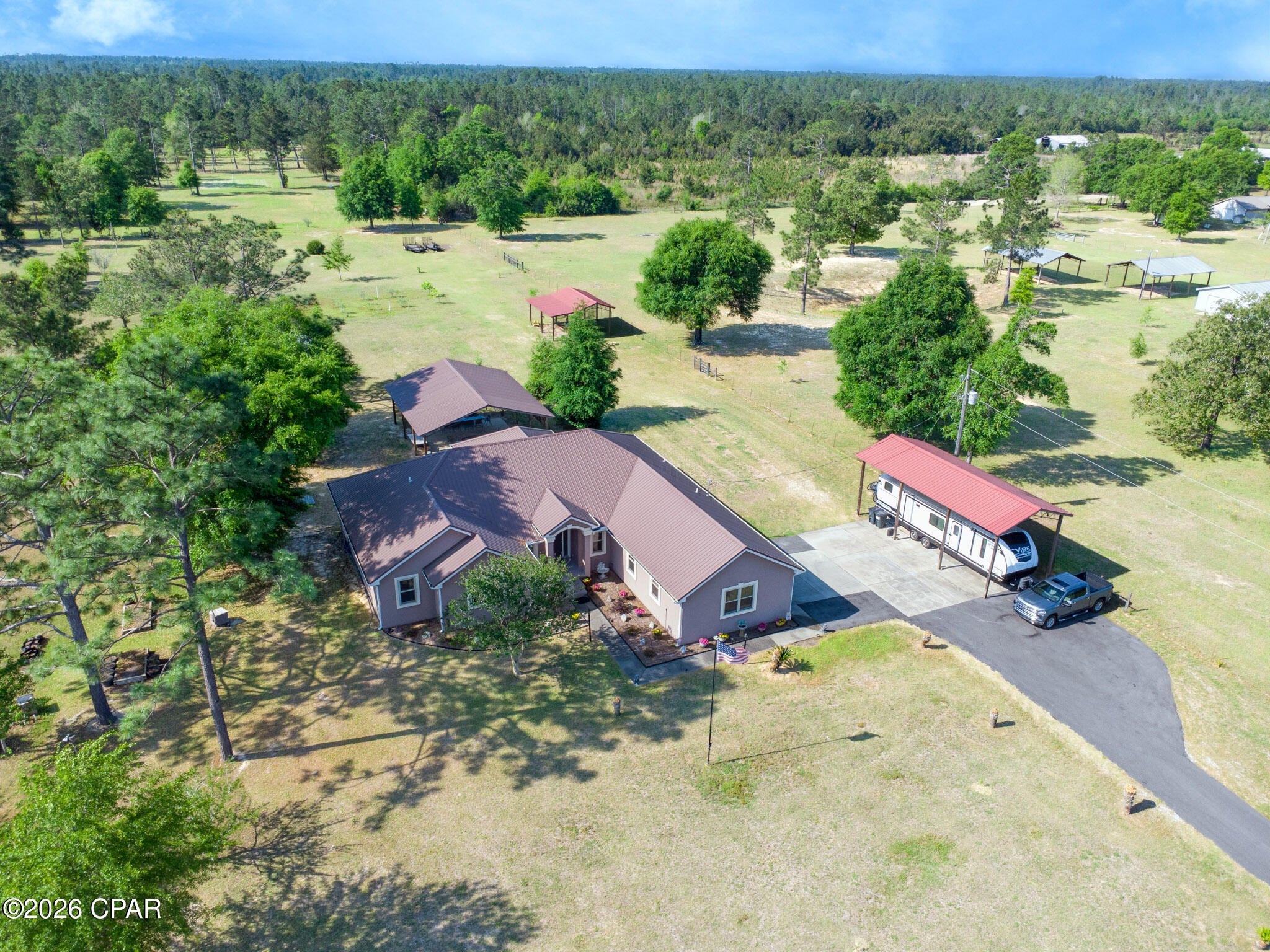 Welcome to your private North Florida retreat on 5 beautiful acres in Fountain! This custom-built 3BR/2.5BA home offers the perfect blend of comfort, functionality, and country living with approximately 2,800+ square feet of thoughtfully designed living space and an unmatched setup for RV owners, hobbyists, homesteaders, or anyone needing room to spread out. Two bonus rooms could easily be converted to make this a 5 bedroom home! 

Loaded with upgrades, this property features a durable metal roof, whole-home 23KW generator, whole-home dehumidifier system, luxury vinyl plank flooring, ENERGY STAR appliances, gas range, oversized kitchen island, spacious living areas, and two flexible spaces that could easily serve as an office, home gym, or media room. 

Step outside and discover what truly makes this property special. The land is usable, functional, and ready for your lifestyle with multiple outbuildings including a 36x40 pole barn outside the Florida room, 22x24 pole barn, 20x24 powered workshop, 16x36 RV pole barn complete with 50-amp hookup, plus an additional powered storage shed.  Plenty of room to make your Pool dreams a reality, right outside the backdoor! Established fruit trees throughout the property add to the overall appeal. Bring your RV, boat, trailers, equipment, or animals -- there's room for it all with NO HOA restrictions. 

Whether you dream of homesteading, storing recreational equipment, or simply enjoying the peace and privacy of country living, this property delivers possibilities that are difficult to find in today's market. 

Conveniently located within reach of Panama City and Marianna, while still offering the freedom and privacy buyers crave, this move-in ready property is the total package for those seeking space, independence, and long-term value.