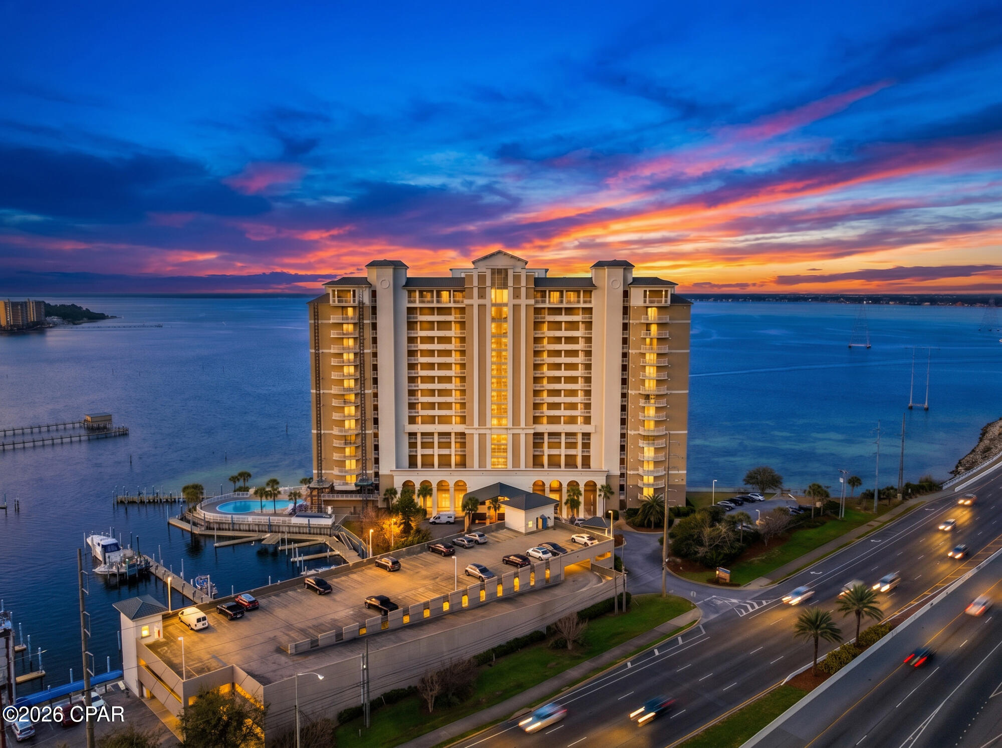Marina Landing #202 is a stunning, fully renovated 2-bedroom, 2-bathroom waterfront condominium offering approximately 1,400 square feet of interior living space plus an expansive 450 sq. ft. balcony overlooking beautiful St. Andrews Bay. Located on the marina side of the building, this residence offers breathtaking sunset views, dolphin and boat watching, and direct access to the waterfront lifestyle. The marina offers boat slips for lease, a private boat club with multiple boats and jet skis, full-service docking and cleaning, and direct access to the Gulf inlet.

The beautifully renovated chef's kitchen features an oversized quartz island, custom stone accents, brand-new cabinetry, stainless steel appliances, and elegant gold hardware and fixtures. The open living area showcases panoramic bay views and a floor-to-ceiling stone fireplace with a new electric insert installed in 2024.

Additional upgrades include LifeProof flooring throughout, a new water heater (2025), new thermostat (2026), fresh interior paint, updated smoke detectors, and spacious bedrooms with floor-to-ceiling windows, private balcony access, and beautiful sunrise views.

Community amenities include a private fitness center, owners' clubroom, private pier, assigned premium parking space, and a large secure storage closet. The building has recently completed exterior painting and stucco restoration. Marina Landing is a peaceful waterfront community with no short-term rentals and a six-month minimum lease policy.

Don't miss the opportunity to own one of Panama City Beach's most desirable waterfront residences. Call me to schedule your private showing!