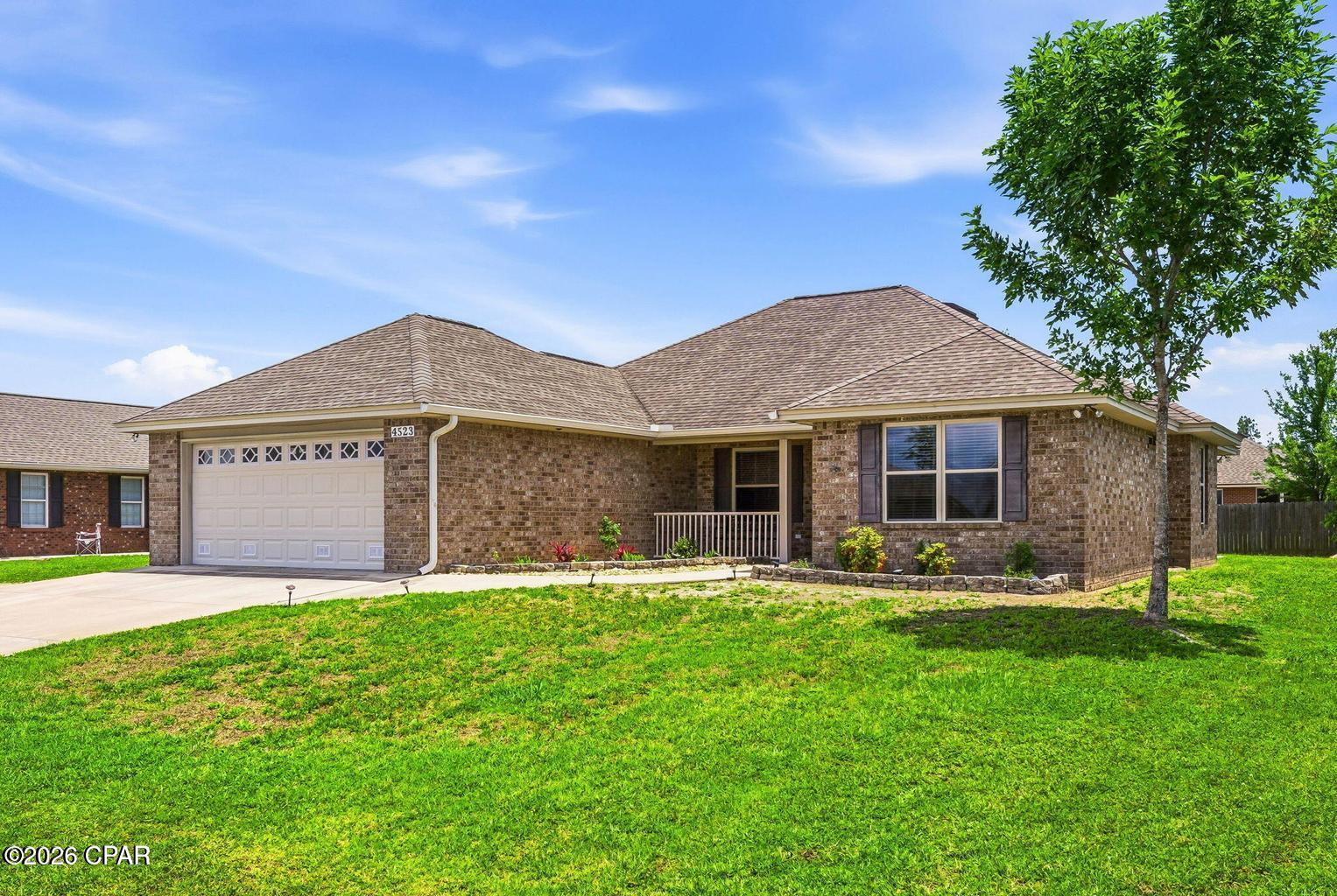 This 4-bedroom 2 bath home has an open, split bedroom floorplan. It features tile flooring, lighted tray ceilings, solid surface countertops and all wood cabinetries. The master bath includes a large bath walk-in shower with benches, ample closet space with a large walk-in closet & extra closet. large master bedroom with lots of room. This attractive all brick home also features an enclosed Florida room, front porch, back patio, fenced back yard, sprinkler system and outdoor shower. Washer & dryer hook up, large living room with fireplace and dining area. Garage offers storage and generator hook up. Close to everything including short drive to Tyndall air base.
