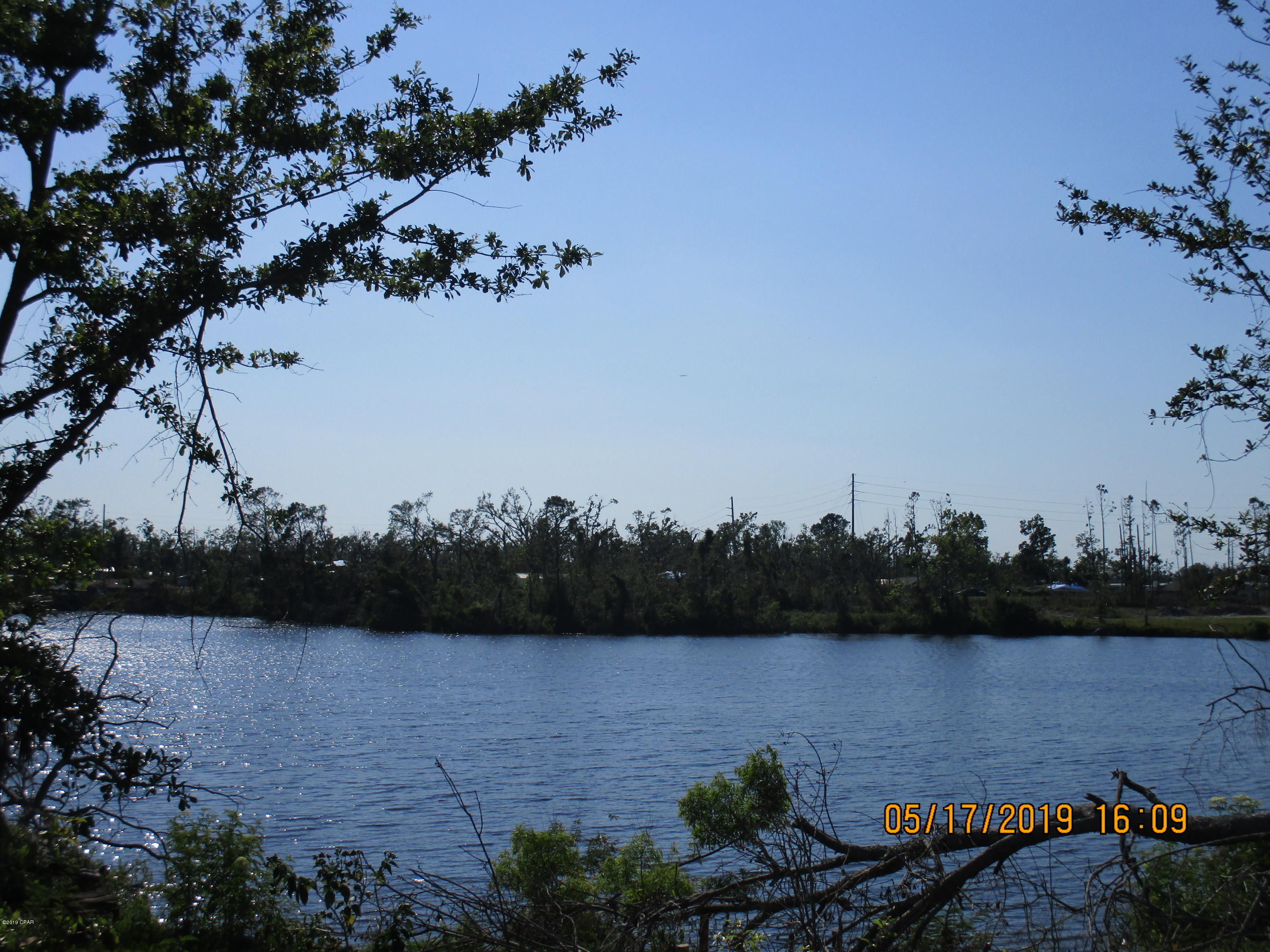 Georgous waterfront lot over 1/3 acre.  Home is storm damaged but the foundation and decking, dock may be usable.  Use caution when viewing this property.  Pump on the property used to pump out of the lake to  water property. Sprinkler system  No warranties.