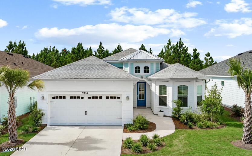 Welcome to 9335 Escape Avenue--a beautifully upgraded, professionally decorated and FULLY FURNISHED Parrot floorplan situated on a preserve homesite in Latitude Margaritaville Watersound. With its sophisticated coastal design, extensive upgrades and peaceful preserve backdrop, this exceptional home has the look and feel of a model--and is truly move-in ready. Step inside and your eye is immediately drawn through three large sliding glass doors to the beautiful preserve beyond. The open-concept kitchen is designed for both entertaining and everyday living, featuring 42-inch Level 2 cabinetry, Level 3 quartz countertops, dovetail soft-close drawers, gas cooking, under- and above-cabinet lighting, pull-outs beside the range and generous pantry storage. The adjoining great room is a showstopper, with vaulted ceiling beams, a wall-mounted TV, colorful electric fireplace and beautifully coordinated coastal décor. Designer lighting, contrasting paint selections and upgraded finishes continue throughout the home, while the dining room features its own distinctive accent wall and stylish décor. A spacious office/bonus room with French glass doors provides a separate area for working, hobbies or additional flex space. The primary suite is generously sized with windows overlooking the preserve, creating a peaceful retreat. Upgraded cabinetry and countertops continue into the primary bath, which offers abundant counter space and a large shower with floor-to-ceiling tile and a seamless glass enclosure. The guest bedroom is privately positioned toward the front of the home with the second full bath conveniently located just outside the bedroom door. Even the laundry room has been thoughtfully upgraded with upper and lower cabinetry, and added storage. Additional features include 8-foot interior doors, 6-inch baseboards, recessed lighting, 2-inch blinds throughout, beautiful laminate flooring, epoxy flooring in the garage and lanai, an upgraded garage door opener, garage utility sink, water filtration system, sealed tile grout, and floored attic storage accessed by a higher-end aluminum pull-down ladder. And here's what makes this home especially easy to fall in love with: it is being sold FULLY FURNISHED! The tasteful coastal décor and artwork, interior furniture, patio furniture, major appliances, washer and dryer, upgraded lighting and mirrors are included, allowing you to begin enjoying your Margaritaville lifestyle from the moment you arrive. Items inside cabinets, closets and the garage do not convey. Located in the vibrant 55+ community of Latitude Margaritaville Watersound, residents enjoy an incredible array of amenities, including the Bar & Chill restaurant overlooking the Intracoastal Waterway, live music and events at the Town Square bandshell, Fins Up! Fitness Center, Paradise Pool, Barkaritaville dog park and pet spa, and a full calendar of clubs, activities and entertainment. Best of all, you're just minutes from the sugar-white beaches and emerald waters that make this area so special. Escape into your beautiful piece of paradise at 9335 Escape Avenue!
