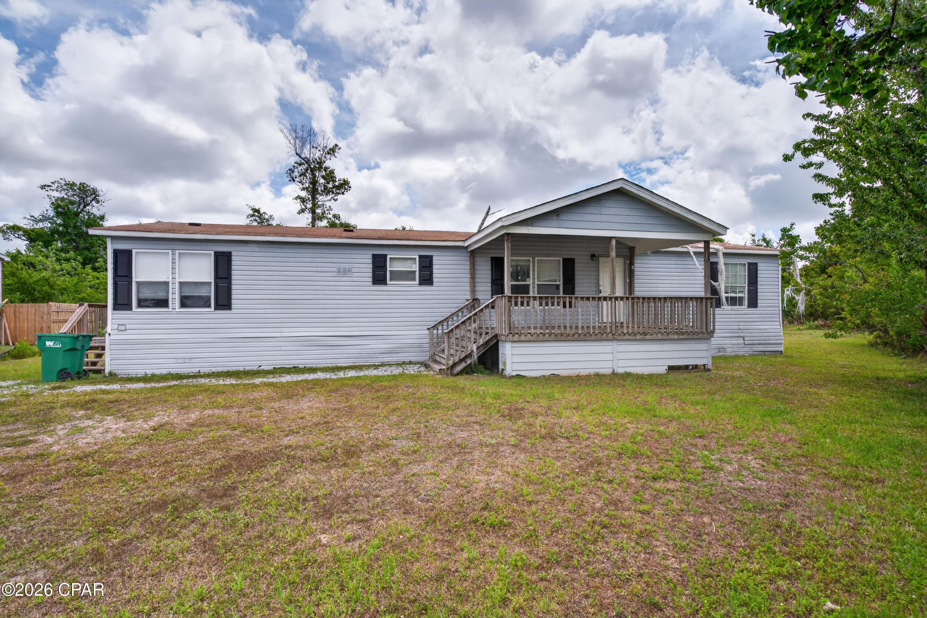 BRING ALL CASH OFFERS! No financing offers will be considered.  Perfect opportunity for DIYers, investors, or first-time homebuyers looking to build instant equity! This spacious 3-bedroom, 2-bath mobile home is tucked away at the end of the street and backs up to a wooded area, offering extra privacy and a peaceful setting. With a little TLC and new flooring throughout, this home has incredible potential to shine.

Enjoy outdoor living with two oversized decks, including a covered 10x16 front deck that's perfect for relaxing with your morning coffee or entertaining guests. The chain-link fenced backyard is ideal for pets, kids, or extra outdoor enjoyment. Inside, the spacious living room features sliding glass doors leading to the back deck, creating a bright and open feel.

The huge kitchen offers an abundance of cabinet and counter space, a breakfast bar, and a roomy dining area perfect for family meals or gatherings. All appliances except the dishwasher are included, making move-in even easier. The split-bedroom floor plan provides added privacy, with generously sized bedrooms throughout. The master suite features two closets, including a walk-in closet, plus a garden tub and convenient access to the laundry room.

Conveniently located just minutes from Tyndall Air Force Base, Eastern Shipbuilding Group, and downtown Panama City, this property offers easy access to work, shopping, dining, and entertainment. Whether you're searching for an affordable primary residence, rental investment, or your next renovation project, this home is packed with potential and value. Home has mold.