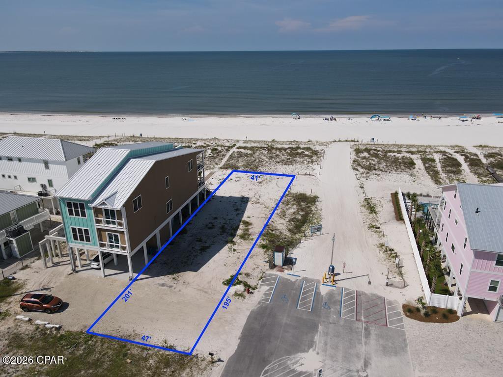 Welcome to 117 S. 37th Street D, a rare Gulf-front lot in Mexico Beach offering 47 feet of direct Gulf frontage and nearly 200 feet of depth on 0.20 acres. Tucked at the end of a quiet dead-end street, this lot sits far enough off Hwy 98 that you truly feel removed from the hustle, yet you are still right in the heart of Mexico Beach. One of the biggest advantages here is that the hard work has already been done -- an active DEP permit with an approved building footprint is in place, saving a buyer roughly a year of planning and permitting. The approved plans call for a 22.7x80-foot, three-story residence with a 10x15 gunite pool beneath the structure, a 138-foot dune walkover to the beach, and a gravel driveway, giving you a construction-ready canvas from day one. The city has also confirmed that the new structure can reconnect to the neighboring units to the east, opening the door for two duplex units on this parcel, a significant value-add for investors or those looking to maximize the property. The future Al Cathey pier will be located right next to this property, adding even more long-term value and appeal to this already outstanding location. Utilities, including water, sewer, electricity, and natural gas, are all available at the site. Gulf-front lots with permits already in hand are incredibly hard to come by in Mexico Beach, and this one checks all the boxes. Call today!