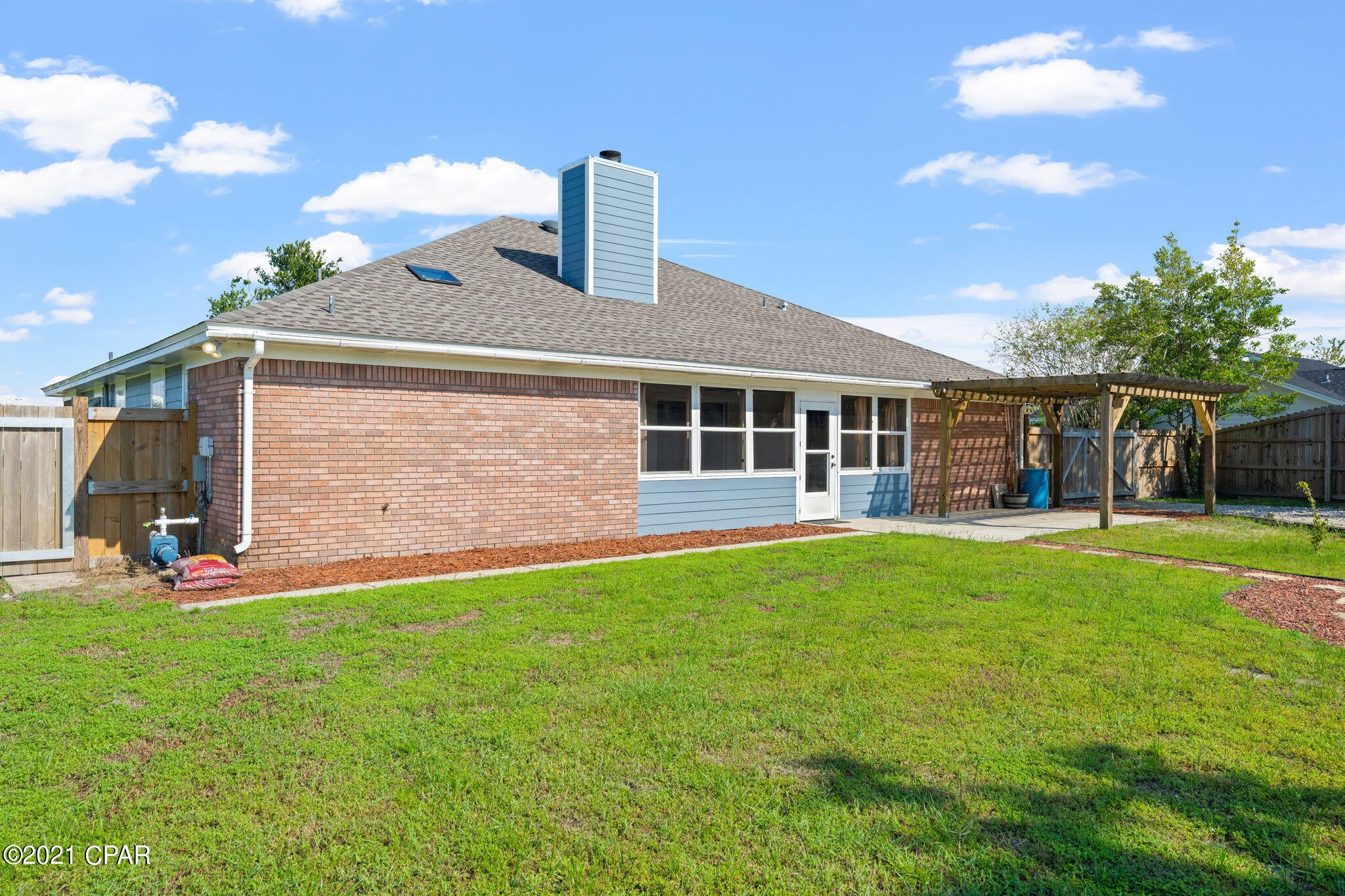CURRENTLY UNDER CONTRACT, SELLER ACCEPTING BACKUP OFFERS. New carpet, new roof, new woodgrain tile floors, new paint and so much more – This home is move in ready! The living room is bright, has a wood fireplace and vaulted ceilings giving it an open feeling.  The chef will appreciate the large kitchen with plenty of cabinet space, a farmhouse sink, touch faucet, island and eat in area. The formal dining area could also be utilized as an office or playroom. The master suite is of good size to accommodate your king-sized furniture. The en suite, has a double vanity, 2 walk in closets and an additional linen closet for even more storage. The guest rooms are on the opposite side of the home and have a shared bathroom. With an additional door in place, you can close this area off for more privacy. The Florida room has its own AC/Heat and plenty of windows to bring in the sunshine. Set it up as a gym or make it a posh kenneled area for your fur babies. The double car rear garage is an outstanding addition to the property! It can be used for so much - man cave, guest house or workshop. It's furnished with a kitchenette, full bath, captains' bed, and a loft. The loft has removable gates for easy access to storage. With its own water heater, AC/Heat, lift station and spray foam insulation it is a cozy getaway only feet from the house. Don't want to mess up the man cave? Well, the main garage is the perfect space to tinker on your equipment. It also has AC and insulated doors to keep you cool. The property is on a good size lot which gives you the benefit of a large yard for the kids or fur babies. A pergola and new playground are already in place and the firepit is ready for smores! The additional driveway space is perfect for the RV or boat. It comes with a double gated privacy fence and is set up with full RV service hookups (50-amp outlet, water, and sewer cleanouts). A few other bonus features the owner has added to the home are tamper resistant outlets, oil rubbed bronze fixtures, 5" baseboards, integrated night lights, and the attic storage is lit, cooled, and insulated with spray foam.  New windows are scheduled for mid-Oct install. Make sure to ask your agent for the full list of upgrades! Seller is offering a 1 year home warranty for buyers peace of mind. Mowat Highlands is a popular subdivision, centrally located in Bay County and close to top rated and charter schools. 30 minutes to the beach and 20 min to Tyndall AFB or NSA.