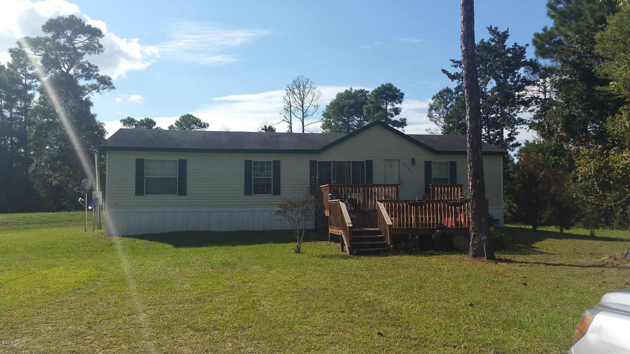 2 Acres and a VERY MOTIVATED Seller!!! for this Beautiful well maintained double wide mobile home built in 2005. This home  sits on a well cared for piece of land 1 acre is cleared and 1 acre is wooded. Property has well built chicken coop and established garden, This home offers an open floor plan with split bedrooms, work shop fit for a king with large covered car port and second floor loft with electricity. The view of the adjoining property is amazing with a fully stocked fish pond that is tranquil and inviting. Seller says bring all offers!