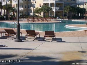 YOU WILL FEEL LIKE YOU ARE LIVING IN A RESORT..One of the Best 2's in complex ... Perhaps largest pool in Bay County (1 acre) w/ two waterfalls, a Splash Pad and plus numerous seating arrangements for your poolside entertaining... all on one level and elevators in the building. This unit is on the ground floor, very desirable, and has a more ''private'' view located in the back of the complex. It is closer to the parking garage so it is just a short walk in and out from your car. The unit has 2 Master Suites and each bedroom has a door to the large private patio overlooking the back close to the 1 acre pool. The rich Bamboo Floors and Granite Countertops throughout along with Stainless appliances make this hard to resist. The complex boasts an indoor H/C Basketball court along with a state of the art Fitness Center. Covered Garage parking so you don't ever get wet coming in from the rain. This won't last long at this price. Resort Living close to everything in Panama City Beach. Beach is 1.4 miles away or 4-5 minute drive from Island Reserve. Cash Buyers only with possibility of a conventional loan through Gulf Bank. No Owner Financing.