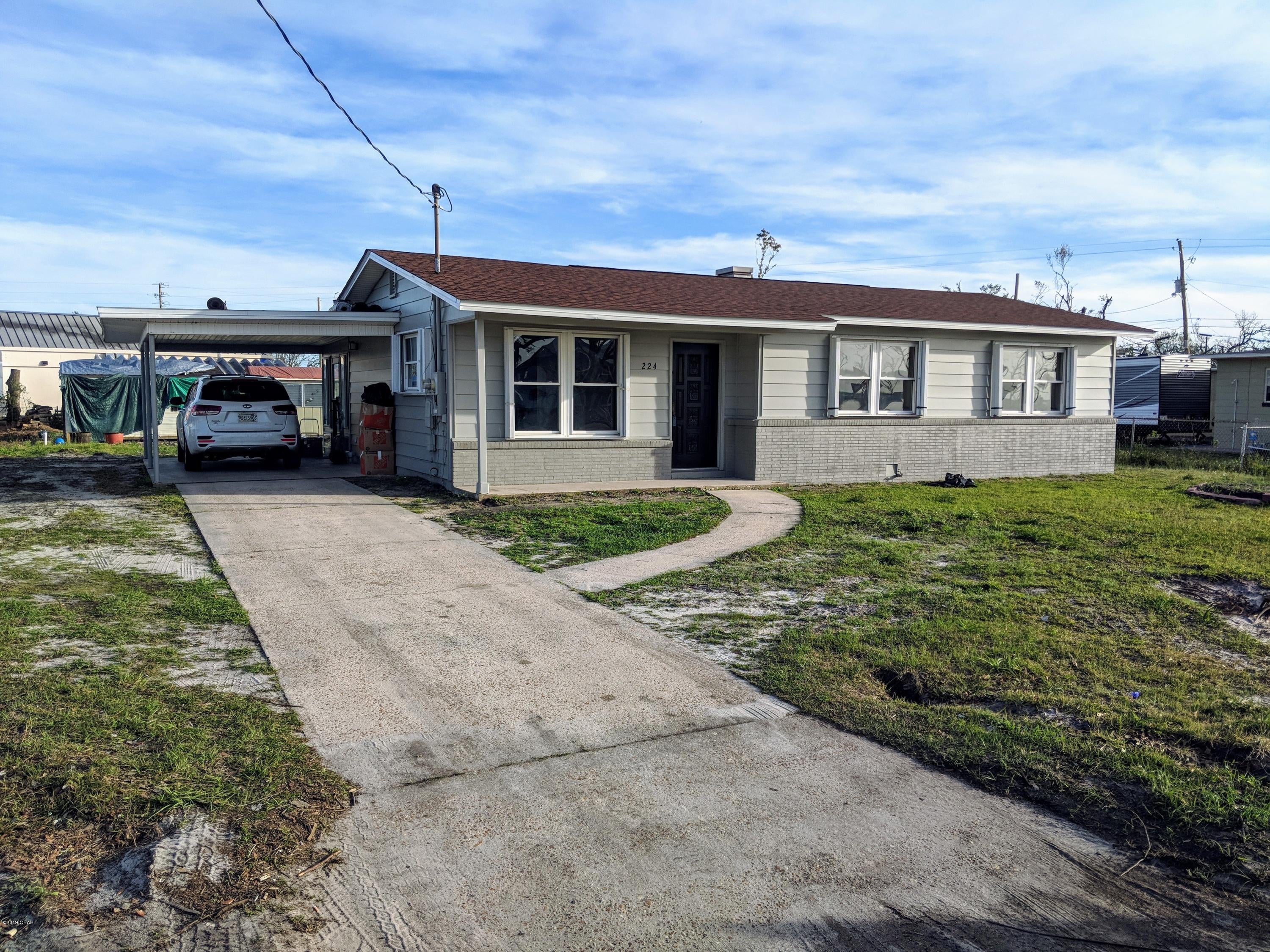Built in 1958, one owner model home with brick and redwood siding, the best back in the day. Today it is an affordable 3 bedroom, 1 bath post hurricane survivor. This home has upgraded electrical, plumbing, windows, hardwood floors and kitchen. New paint inside and out, new roof, and new A/C with a transferable 10 year warranty.  This home is ready move in condition, very clean, fresh and airy, with a large florida room. 5 minutes to Tyndall AFB, shopping, restaurants and most water activities.  Awesome water views from your front porch, and some of the most colorful  sunsets you'll see.  This home is looking for owner #2, call today for your private showing.
